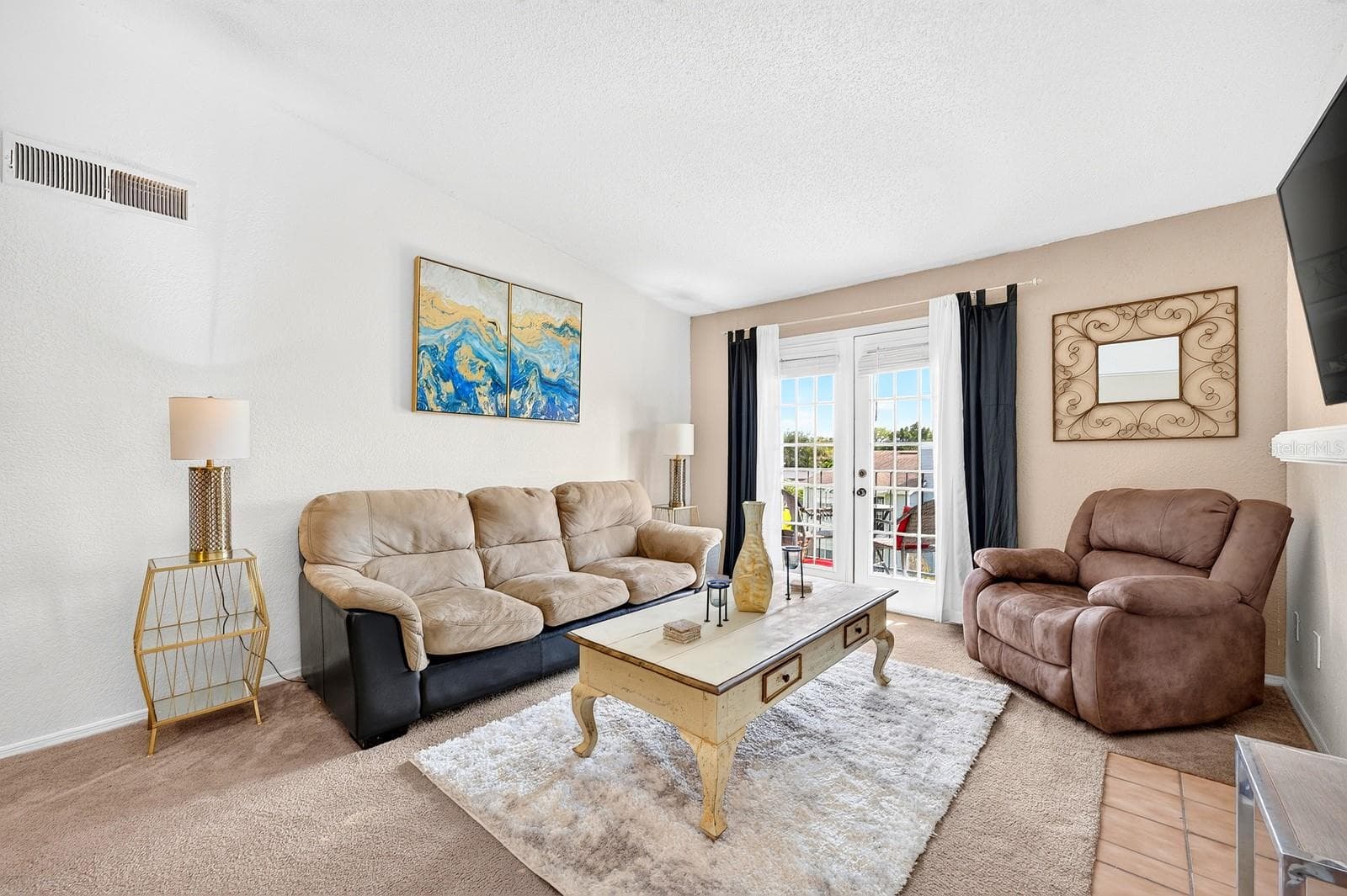 Filled with NATURAL LIGHT, the Living Room features a FIREPLACE and glass-paneled doors that open to the COVERED, SCREENED BALCONY. - 2550 N ALAFAYA TRL #6303, ORLANDO