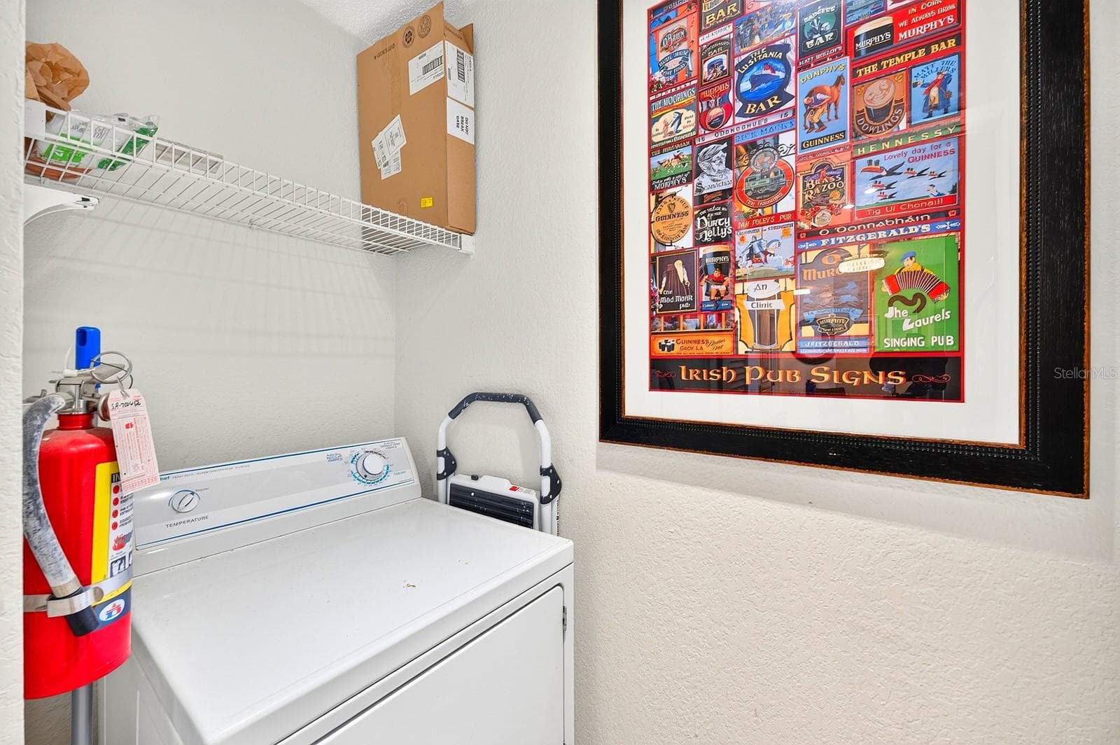 A convenient LAUNDRY ROOM IS TUCKED BEHIND A CLOSET DOOR in the Kitchen, keeping the washer and dryer easily accessible while neatly out of sight. - 2550 N ALAFAYA TRL #6303, ORLANDO