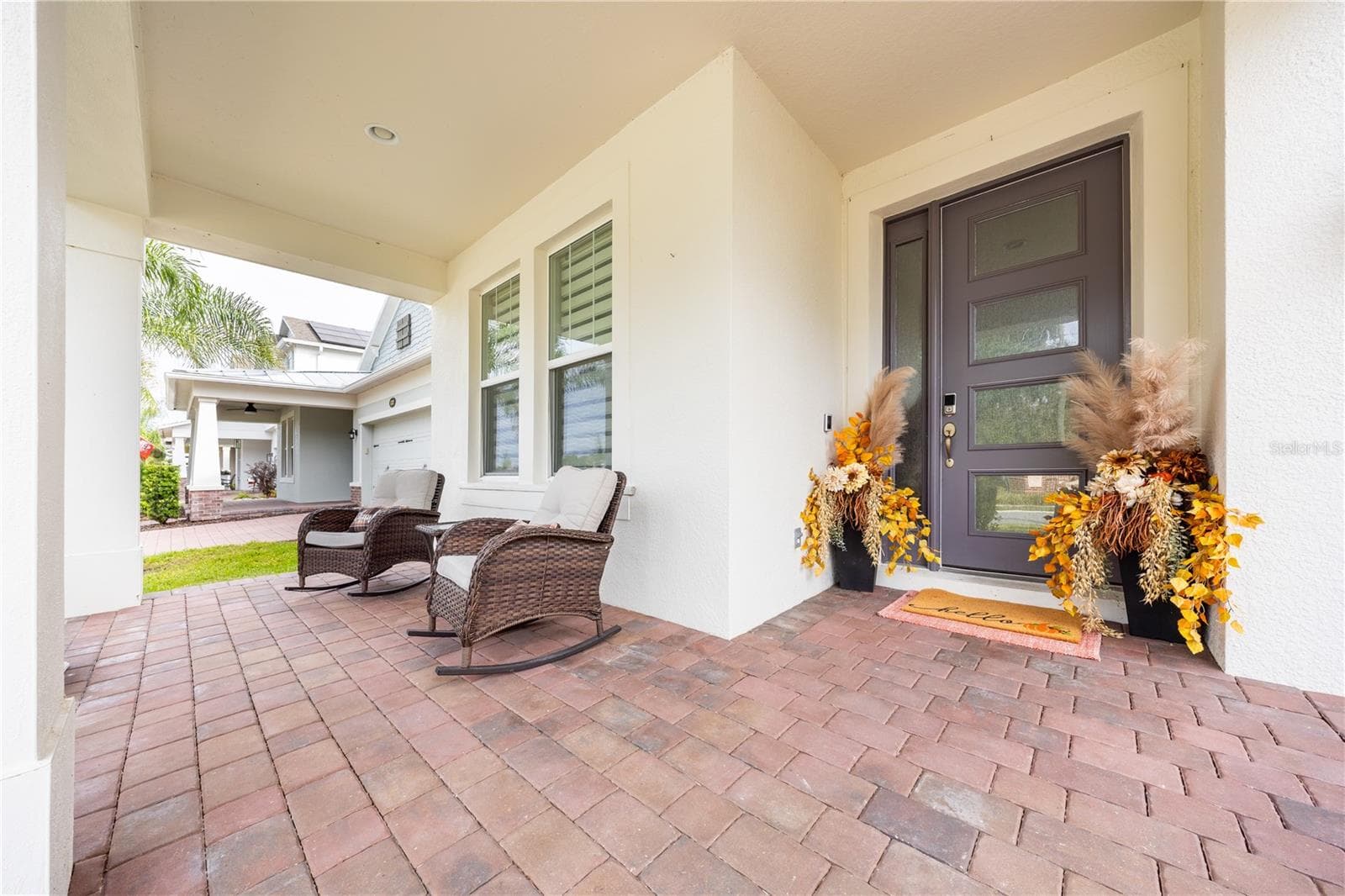 Inviting covered front porch with seating and a stylish entry door. - 1316 SOUTHERN SUN DRIVE, OAKLAND