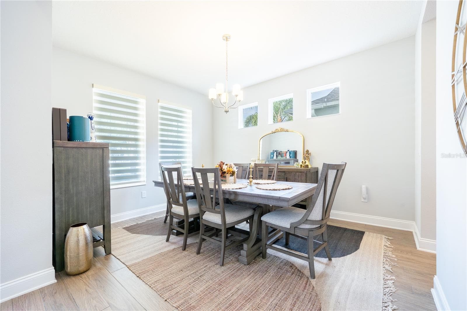 Elegant dining room with abundant natural light and a classic chandelier. - 1316 SOUTHERN SUN DRIVE, OAKLAND