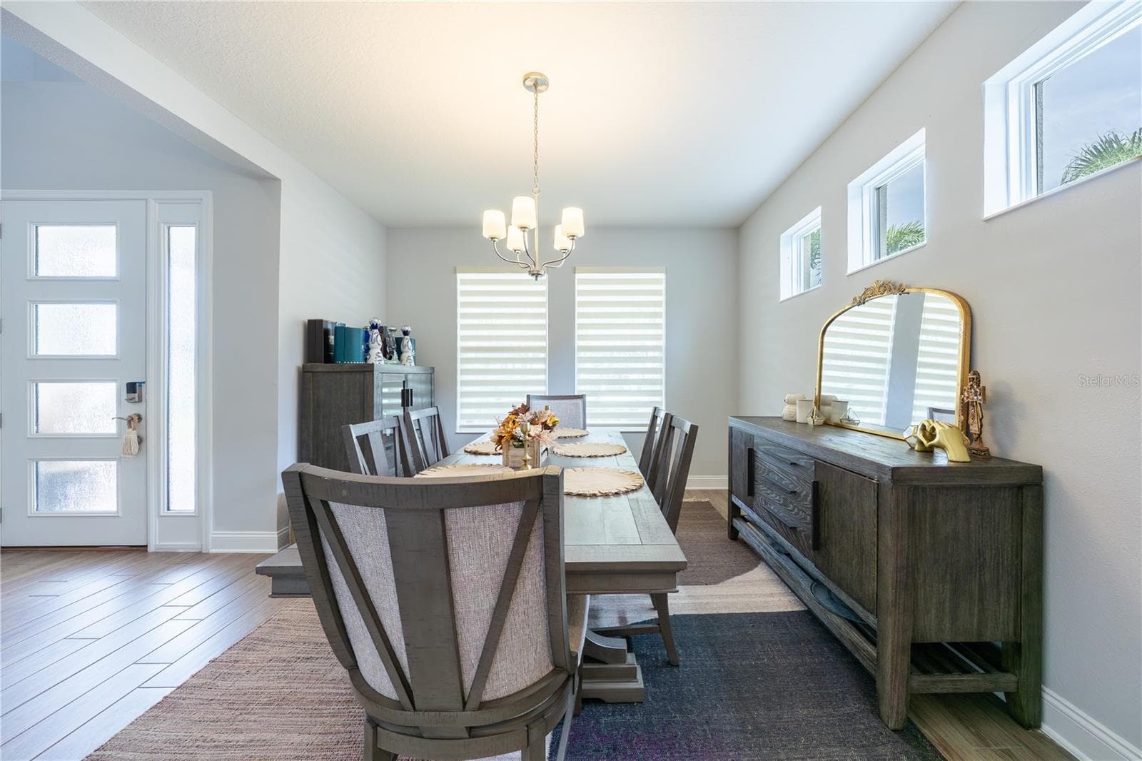 Elegant dining room with high windows and a classic chandelier, just off the foyer. - 1316 SOUTHERN SUN DRIVE, OAKLAND