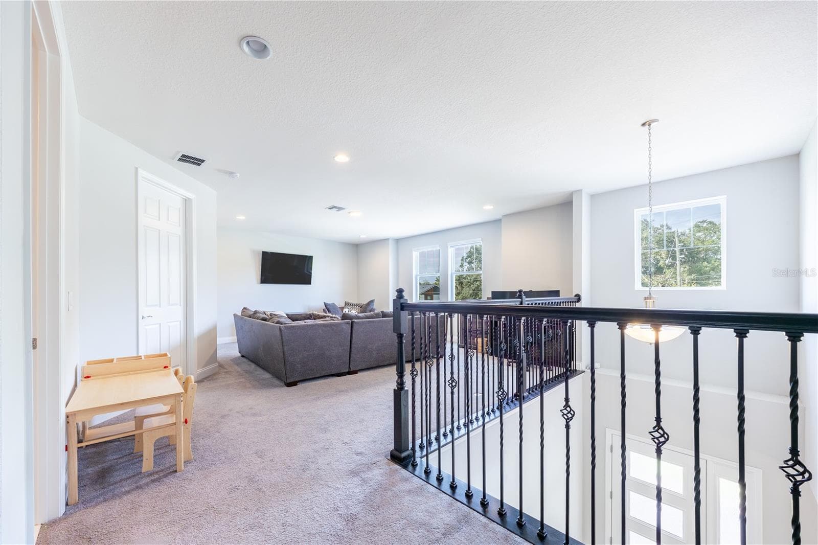 Spacious upstairs loft with a comfortable lounge area and decorative metal railings overlooking the foyer. - 1316 SOUTHERN SUN DRIVE, OAKLAND