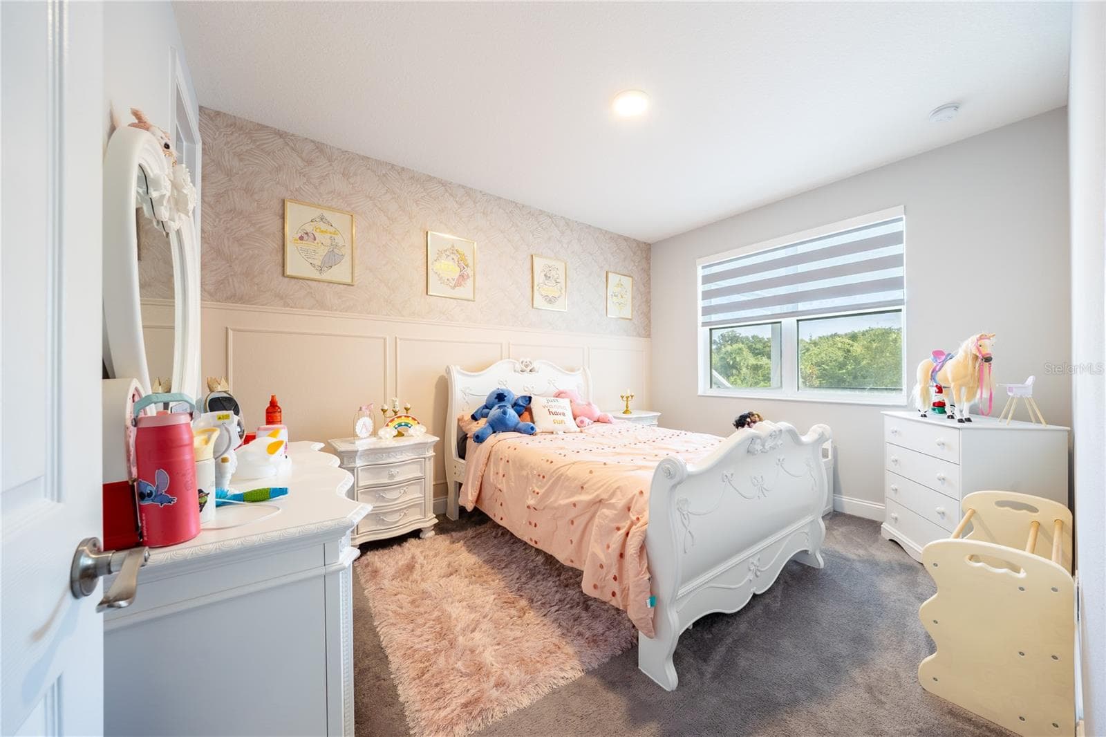 Inviting bedroom with a decorative accent wall, soft carpeting, and views of nature. - 1316 SOUTHERN SUN DRIVE, OAKLAND