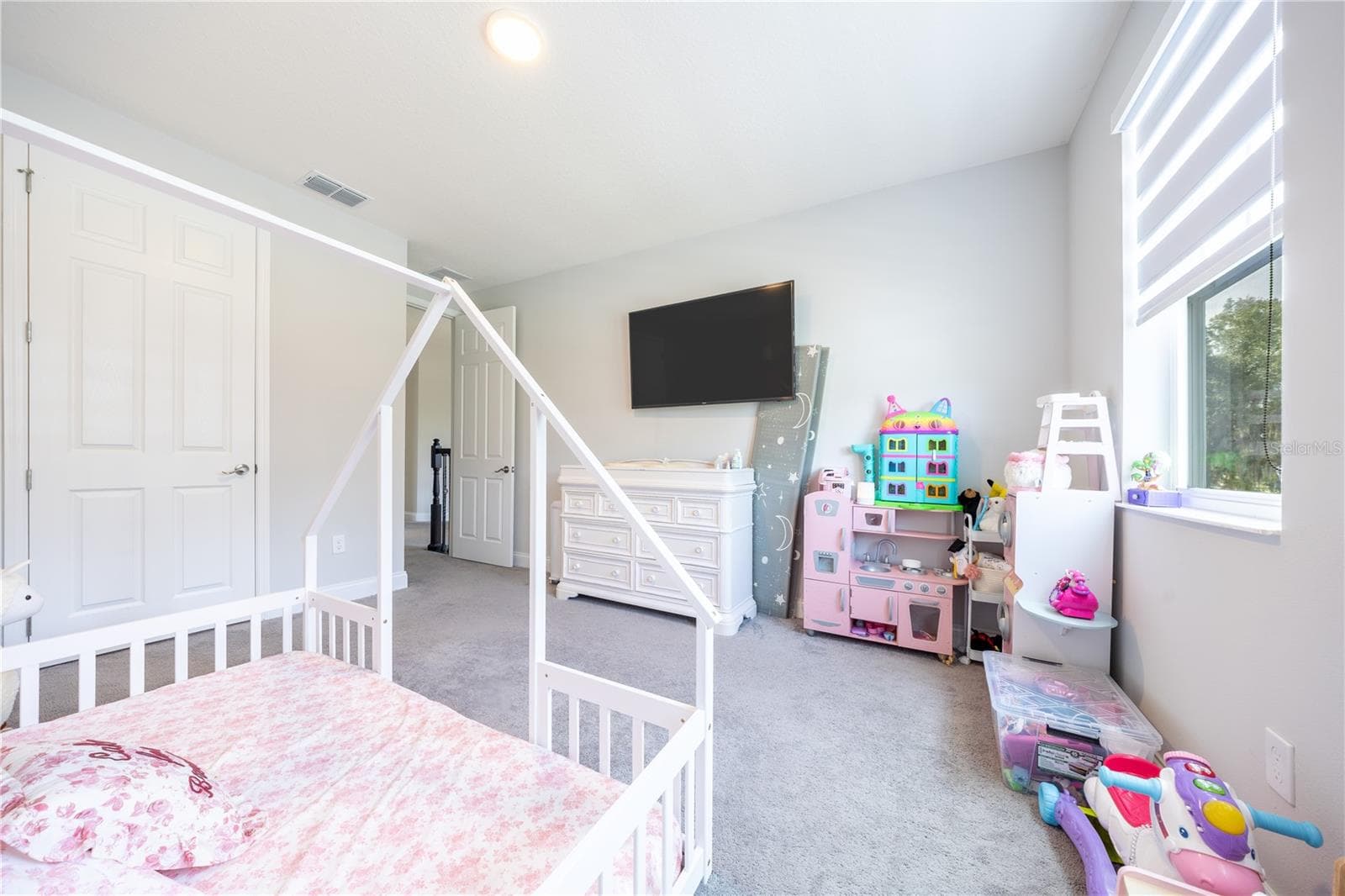 Comfortable bedroom with soft carpeting, a double-door closet, and space for a play area. - 1316 SOUTHERN SUN DRIVE, OAKLAND