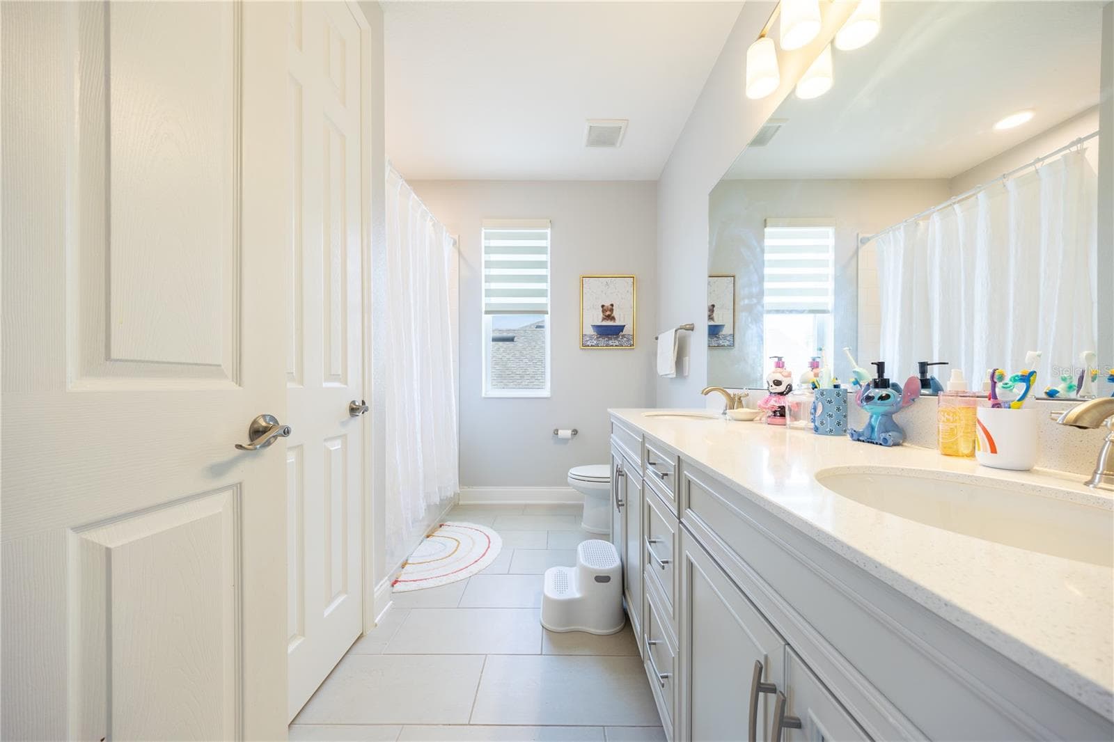 Well-appointed bathroom with a dual-sink vanity, ample storage, and a tub-shower combination. - 1316 SOUTHERN SUN DRIVE, OAKLAND