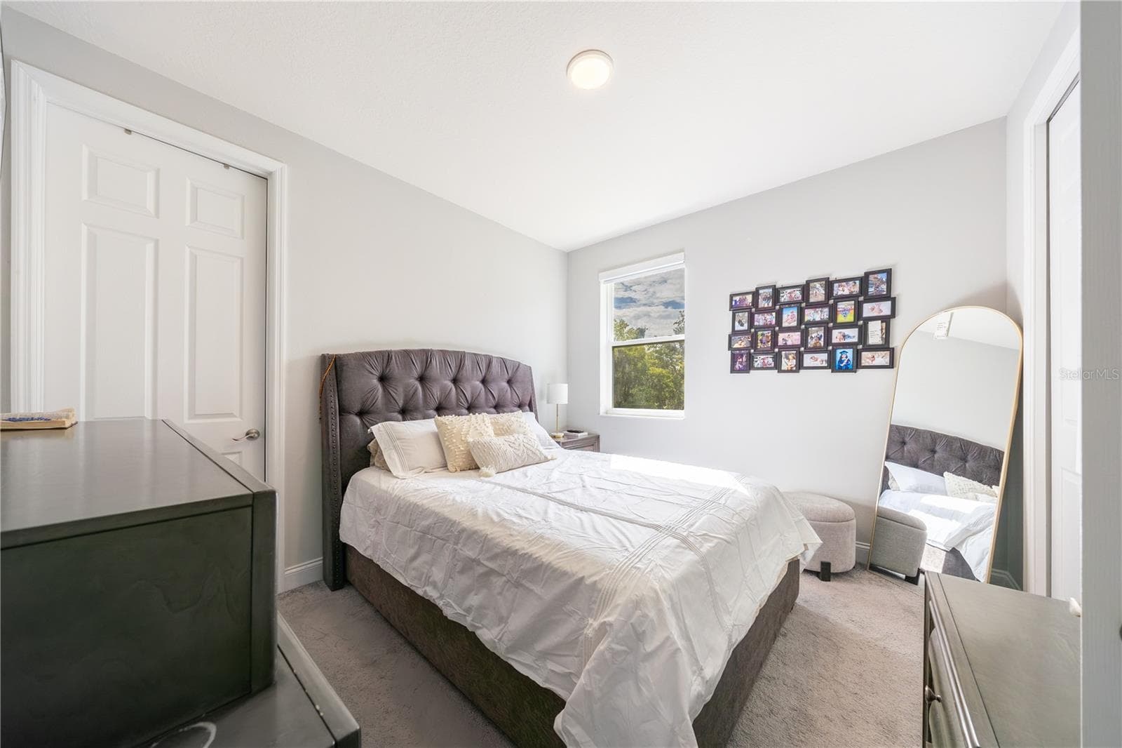 Inviting bedroom with soft carpeting, neutral tones, and a double-door closet. - 1316 SOUTHERN SUN DRIVE, OAKLAND