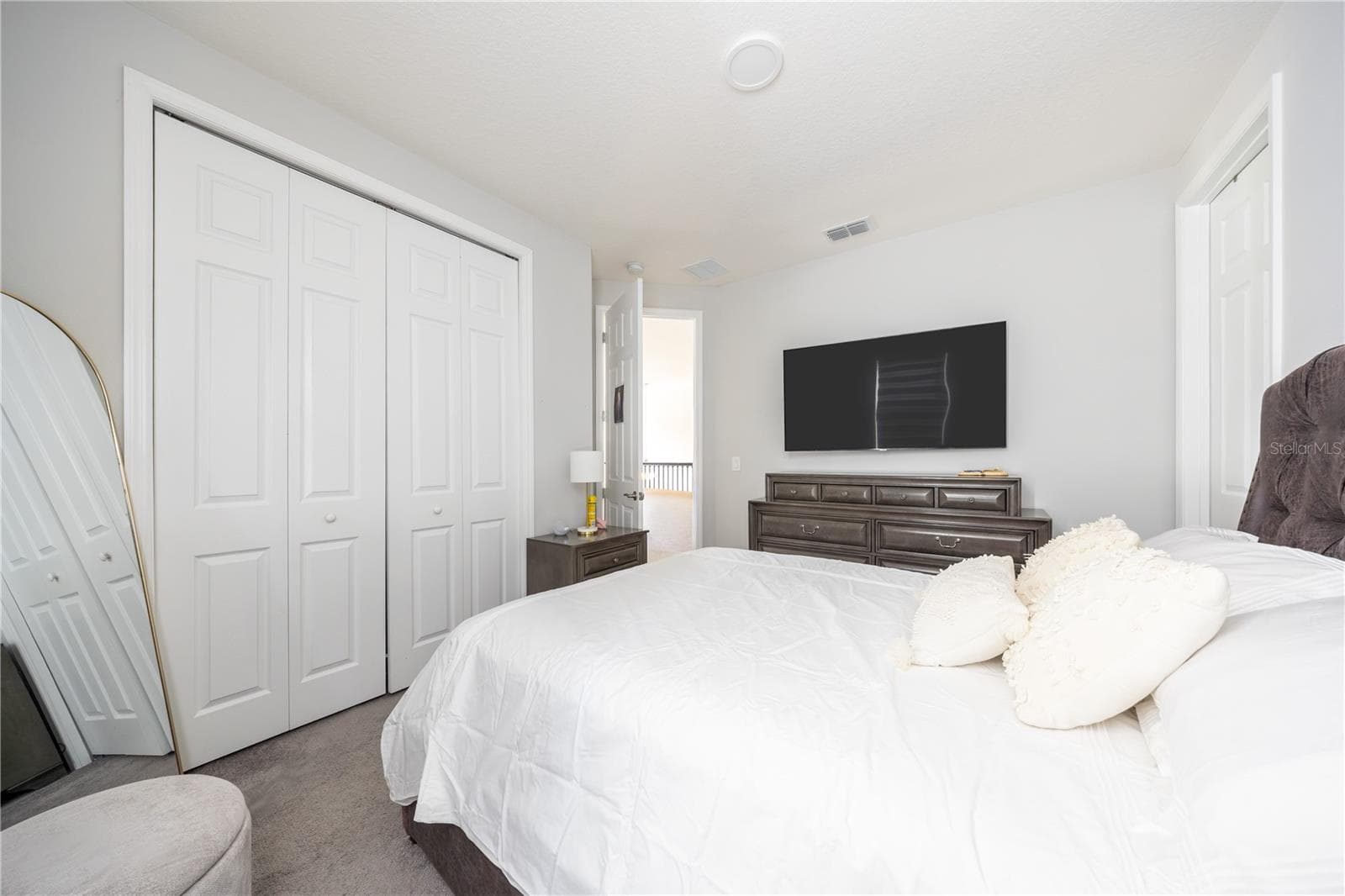 Comfortable bedroom with a spacious closet, soft carpeting, and a refined neutral palette. - 1316 SOUTHERN SUN DRIVE, OAKLAND