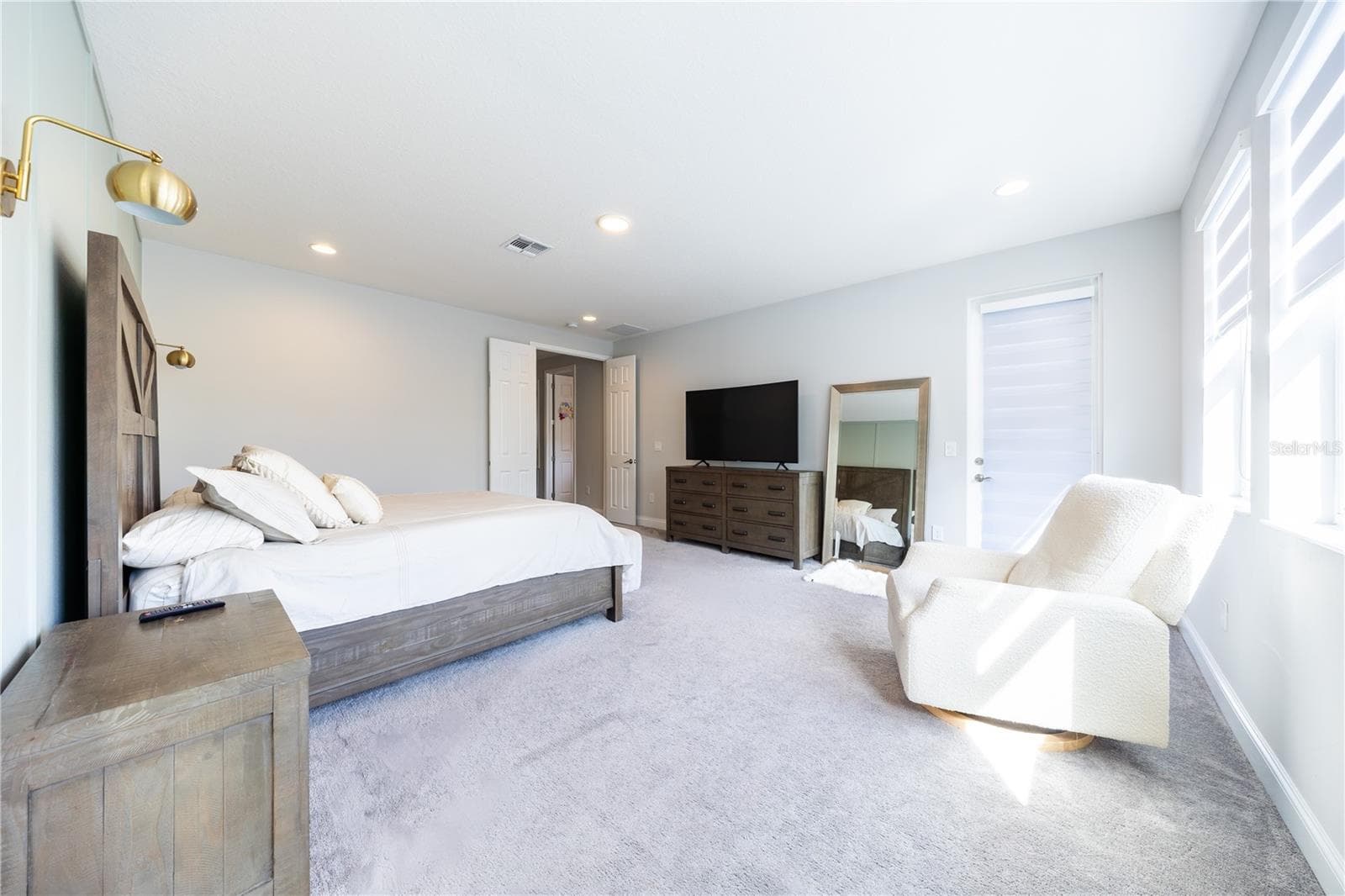 Spacious primary bedroom with a sitting area, double-door entry, and direct porch access. - 1316 SOUTHERN SUN DRIVE, OAKLAND
