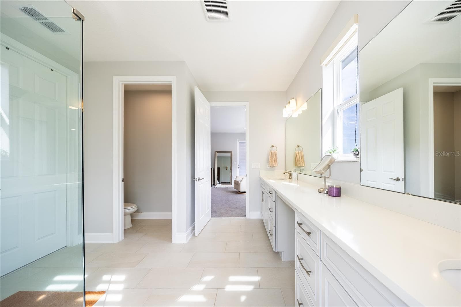 Elegant primary bathroom with an expansive vanity, makeup area, and separate toilet room. - 1316 SOUTHERN SUN DRIVE, OAKLAND