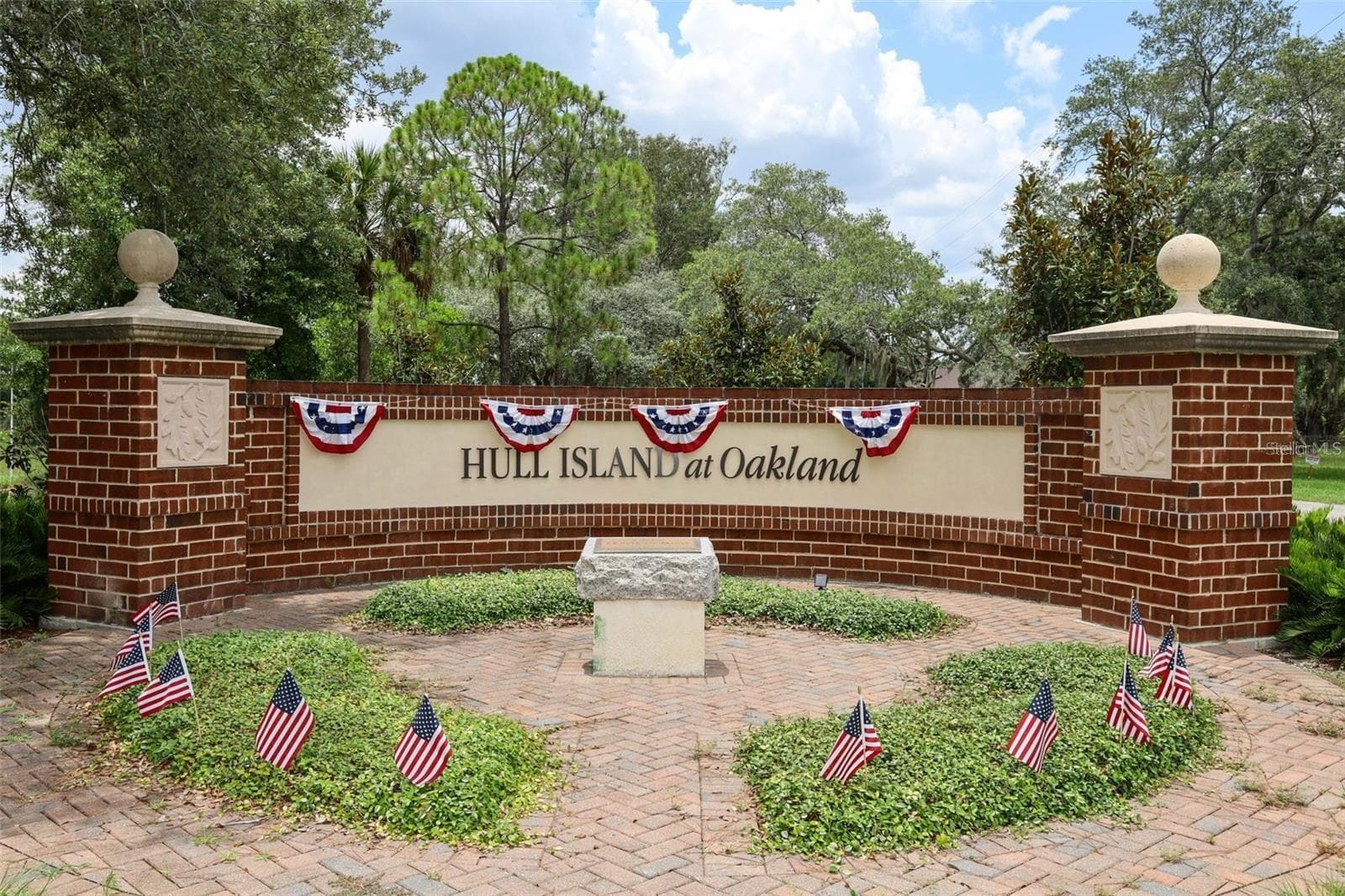 Welcome to Hull Island at Oakland, with a beautifully landscaped entrance framed by mature trees. - 1316 SOUTHERN SUN DRIVE, OAKLAND