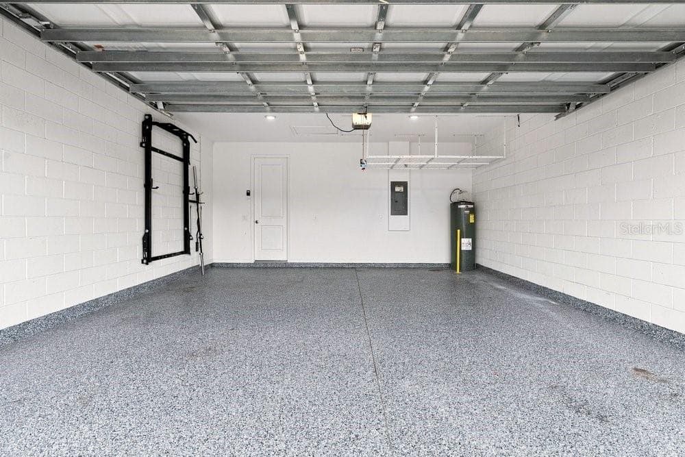 Garage with Epoxy Floors, shelf, and power rack - 2378 GOLD DUST DR, MINNEOLA