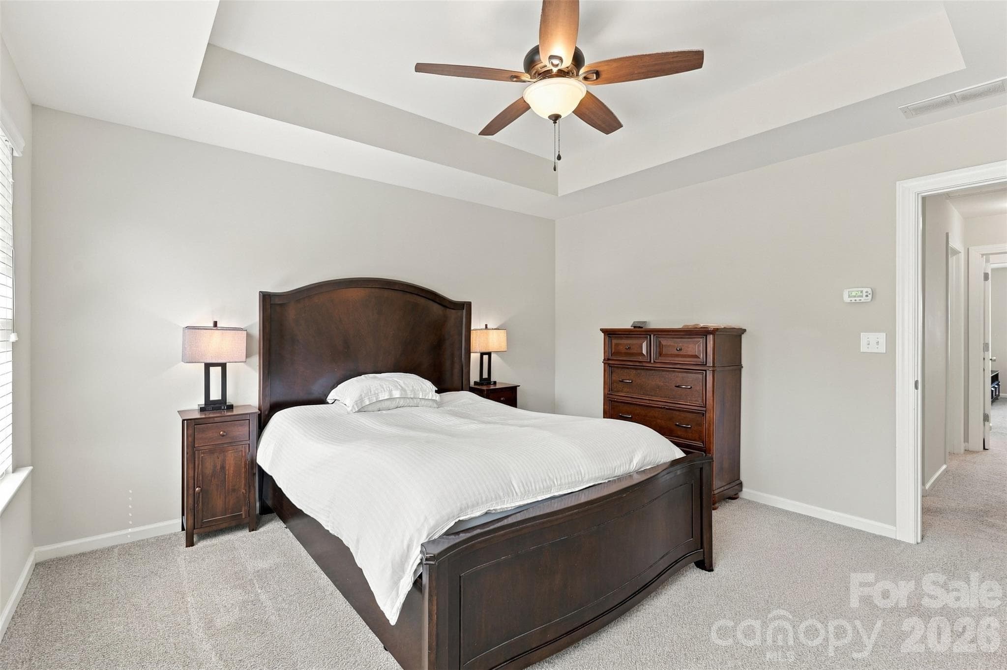Bedroom 2- tray ceiling, ensuite bath with tiled floors, dual vanity, & tub/shower combo! - 1020 Archibald Avenue, Fort Mill