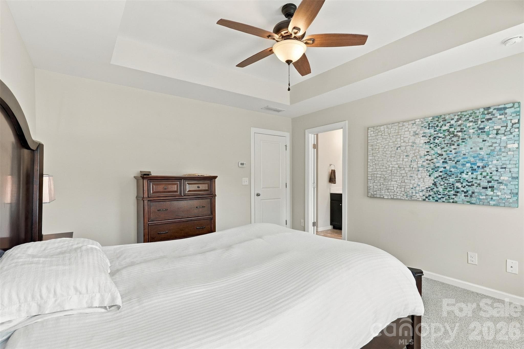 Bedroom 2- tray ceiling, ensuite bath with tiled floors, dual vanity, & tub/shower combo! - 1020 Archibald Avenue, Fort Mill