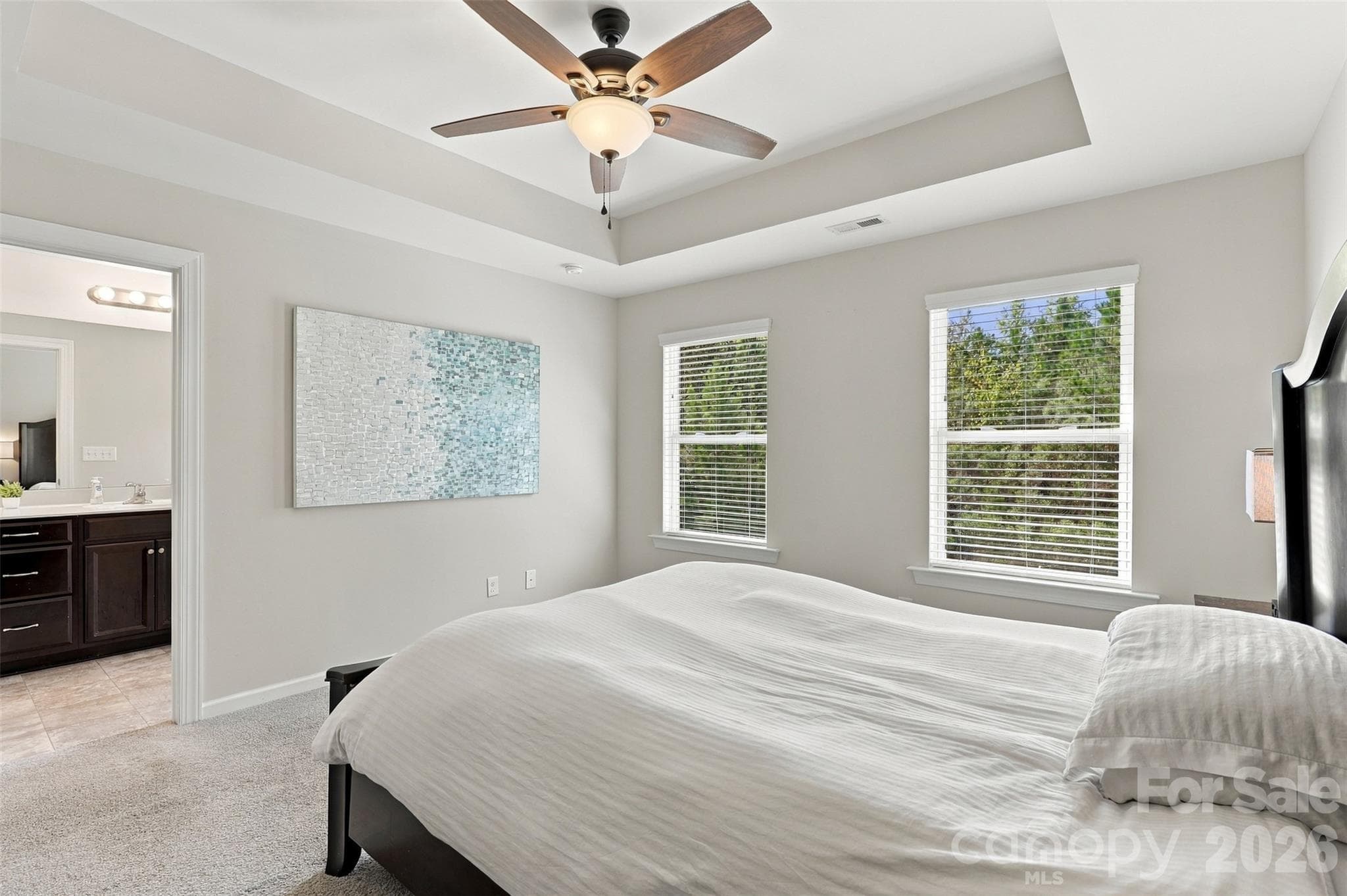 Bedroom 2- tray ceiling, ensuite bath with tiled floors, dual vanity, & tub/shower combo! - 1020 Archibald Avenue, Fort Mill