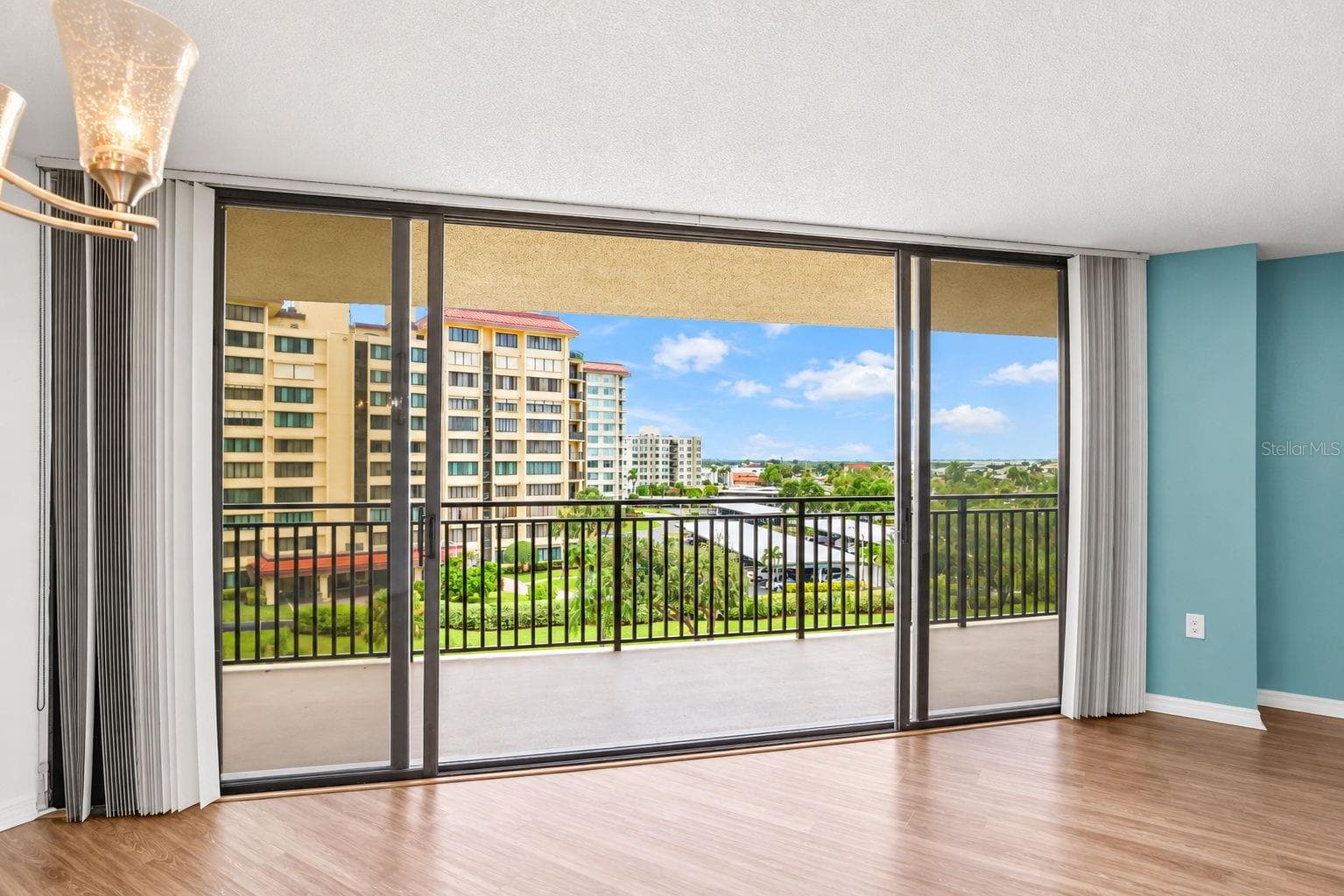 Large sliding doors from living/dining room. with easy close hurricane shutters - 690 ISLAND WAY #606, CLEARWATER