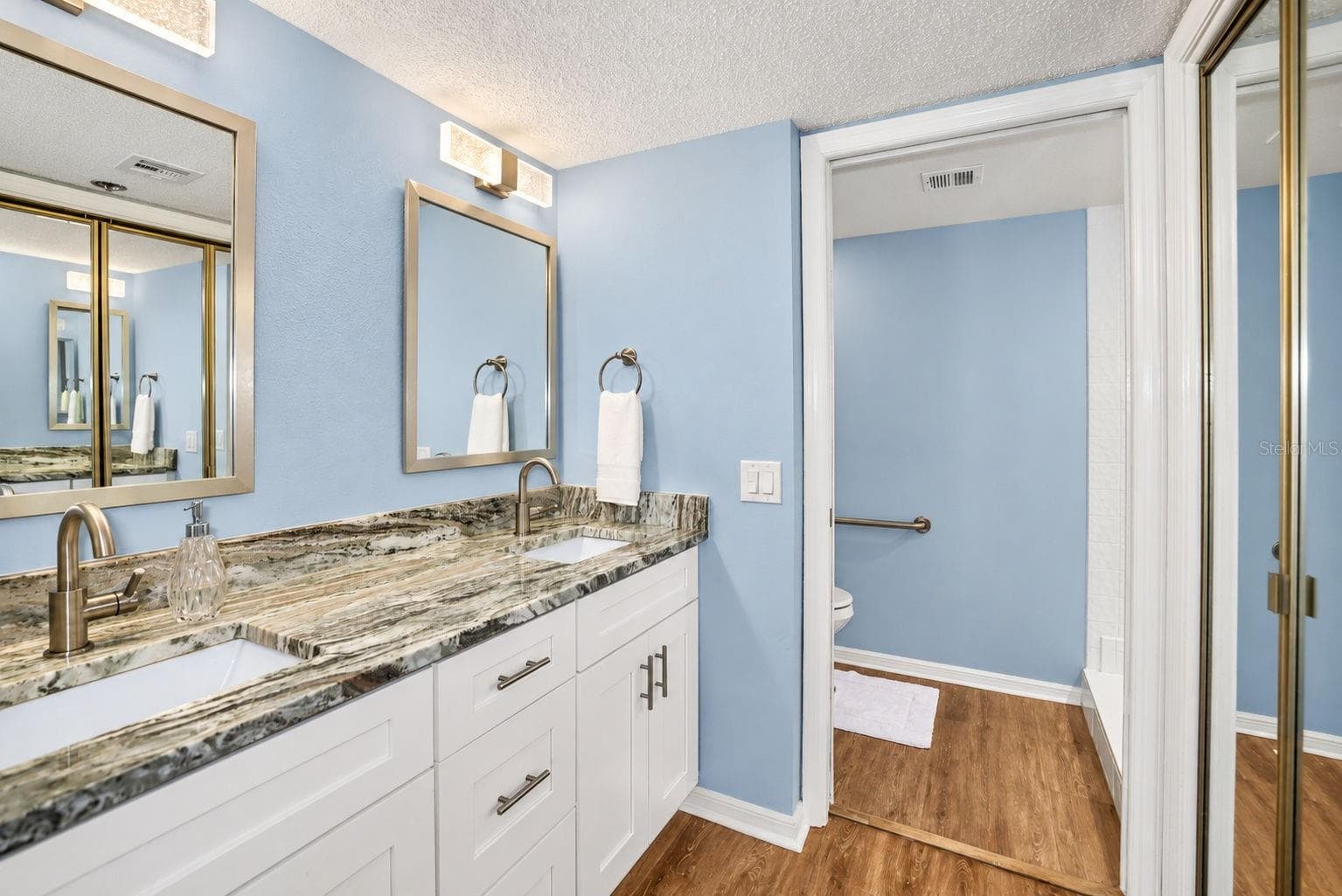 Primary Bathroom, newly updated with double sink shaker cabinet vanity with soft close drawers, lighting, mirrors and paint. - 690 ISLAND WAY #606, CLEARWATER
