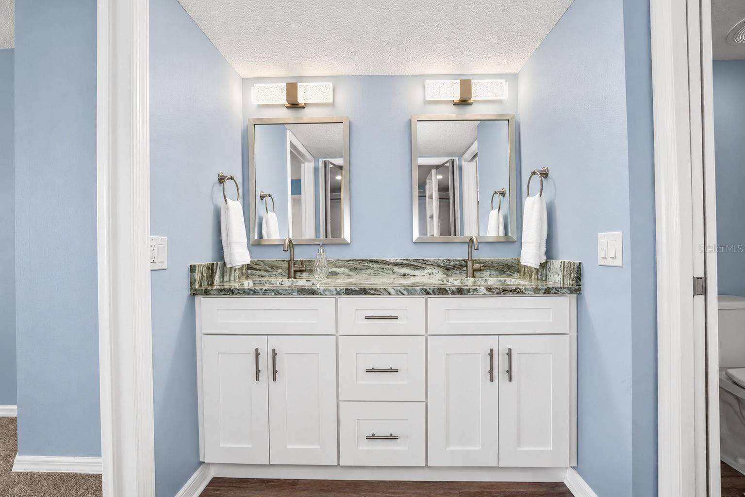 Primary Bathroom, newly updated with double sink shaker cabinet vanity with soft close drawers, lighting, mirrors and paint. - 690 ISLAND WAY #606, CLEARWATER