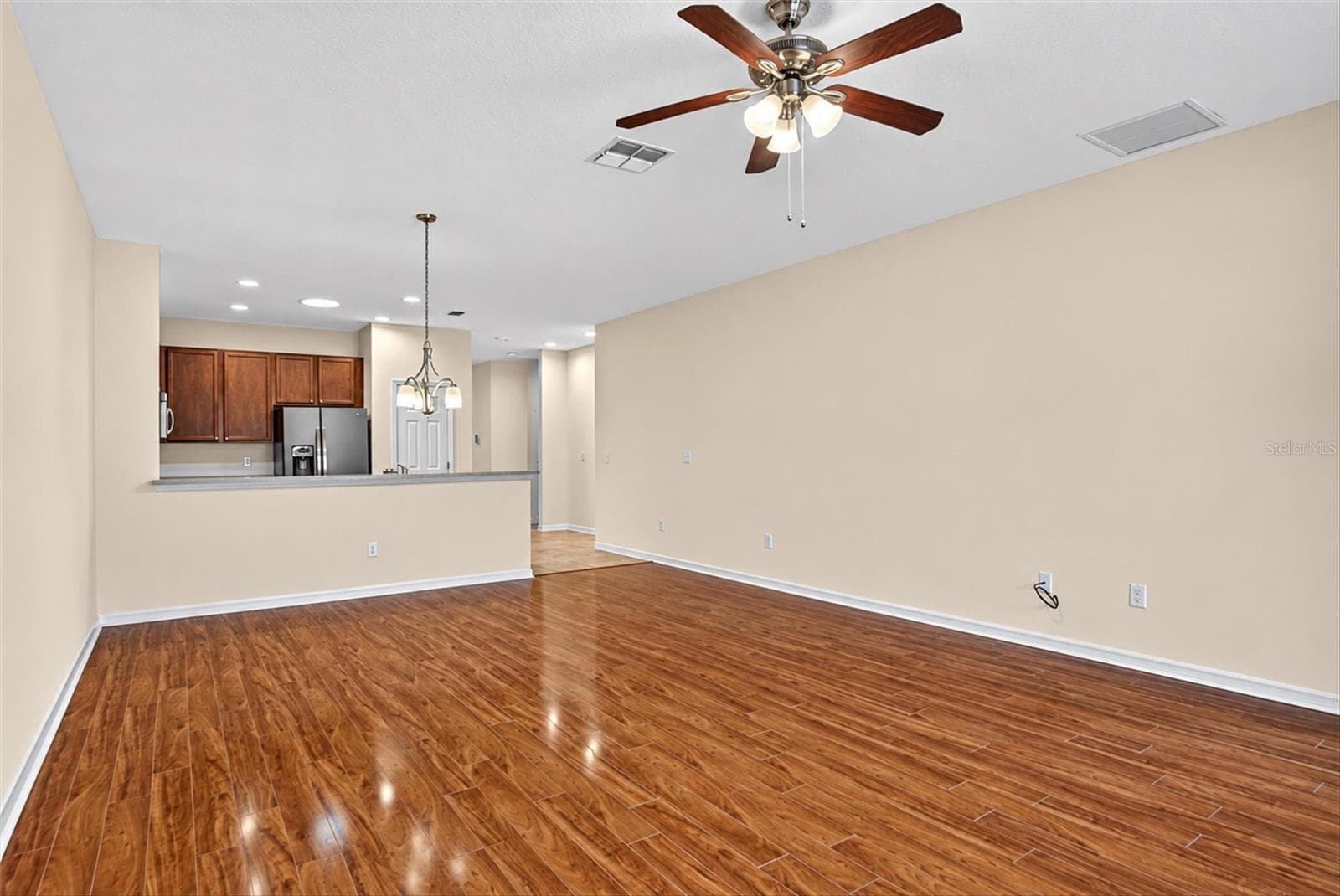 Spacious, freshly painted living area with an open layout and flexible furniture arrangement. - 2153 BARRACUDA CT, HOLIDAY
