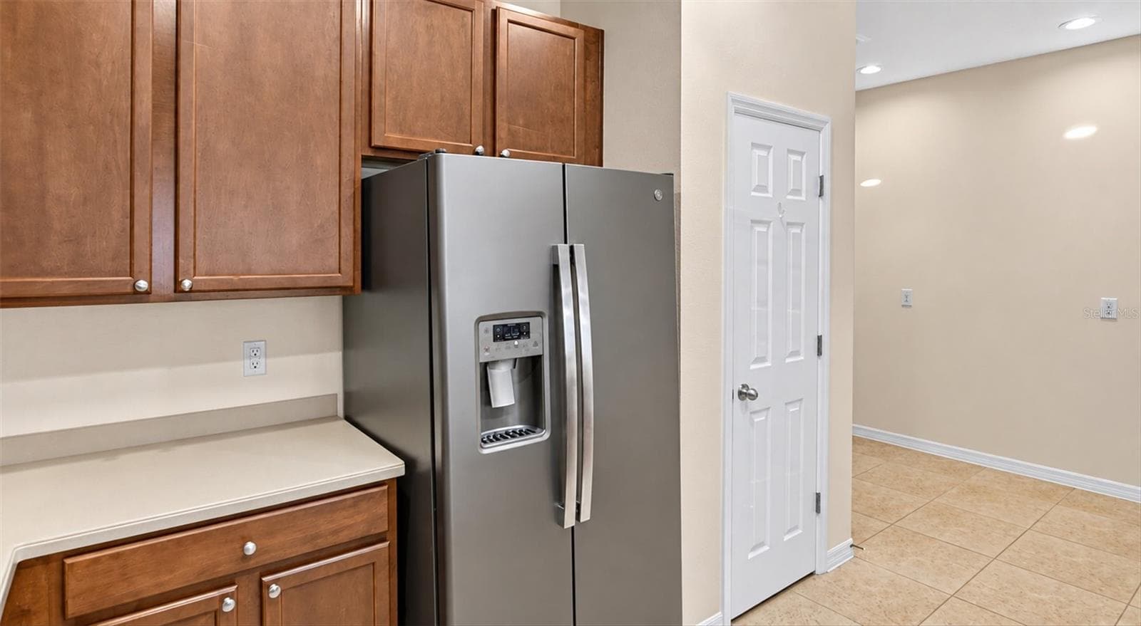 Additional kitchen view featuring stainless steel appliances and generous cabinet storage. - 2153 BARRACUDA CT, HOLIDAY