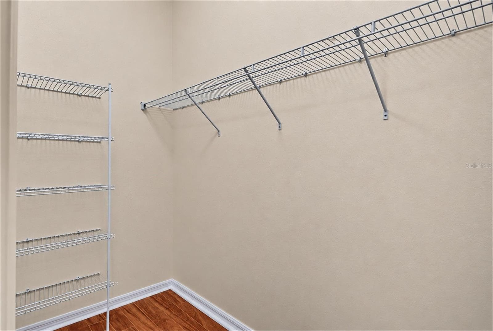 Walk-in closet with built-in shelving and hanging storage. - 2153 BARRACUDA CT, HOLIDAY