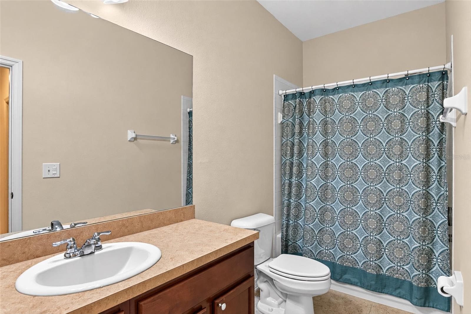 Full guest bathroom with vanity, tub and shower combination. - 2153 BARRACUDA CT, HOLIDAY