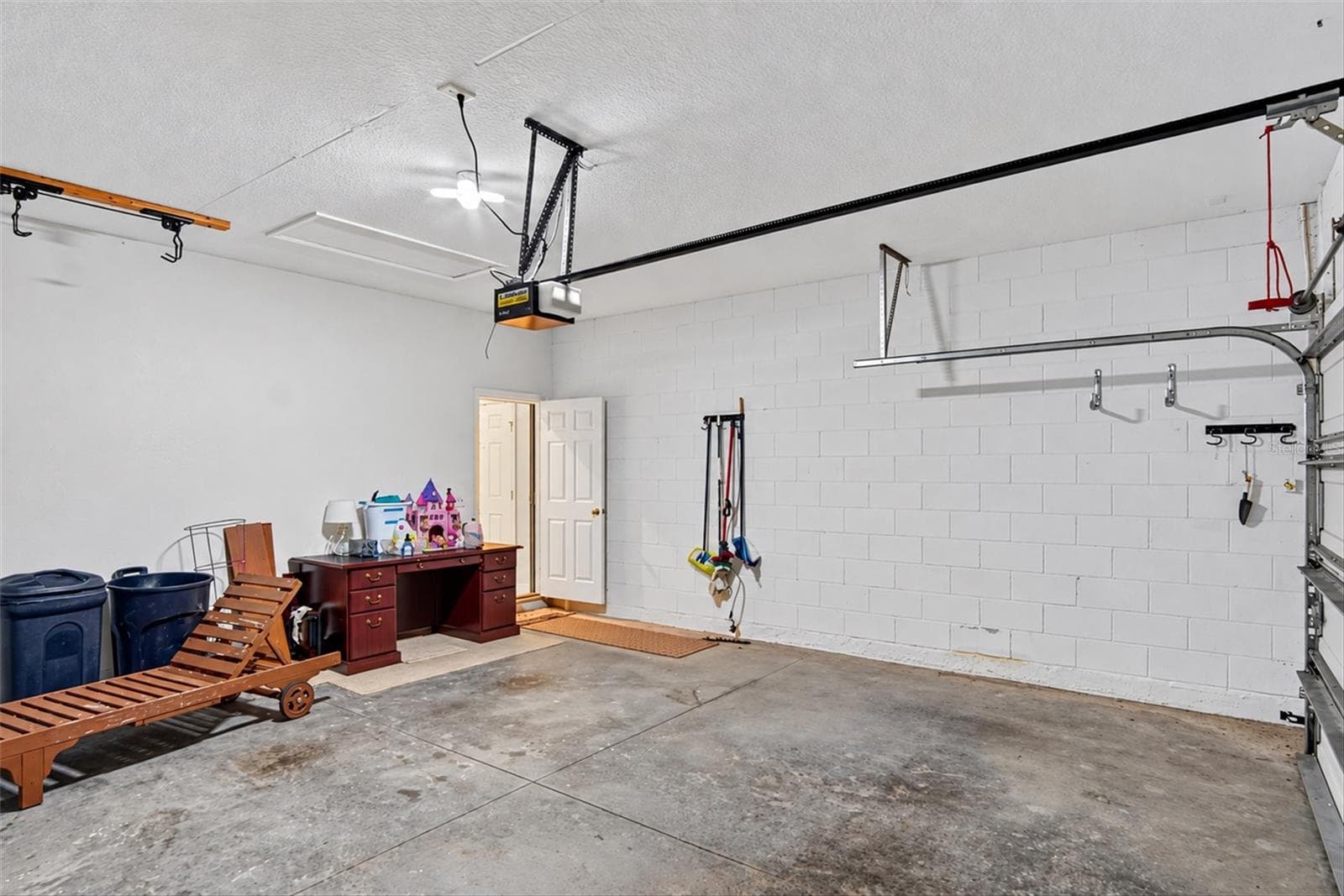 Additional garage view showing the generous parking and storage area. - 2153 BARRACUDA CT, HOLIDAY