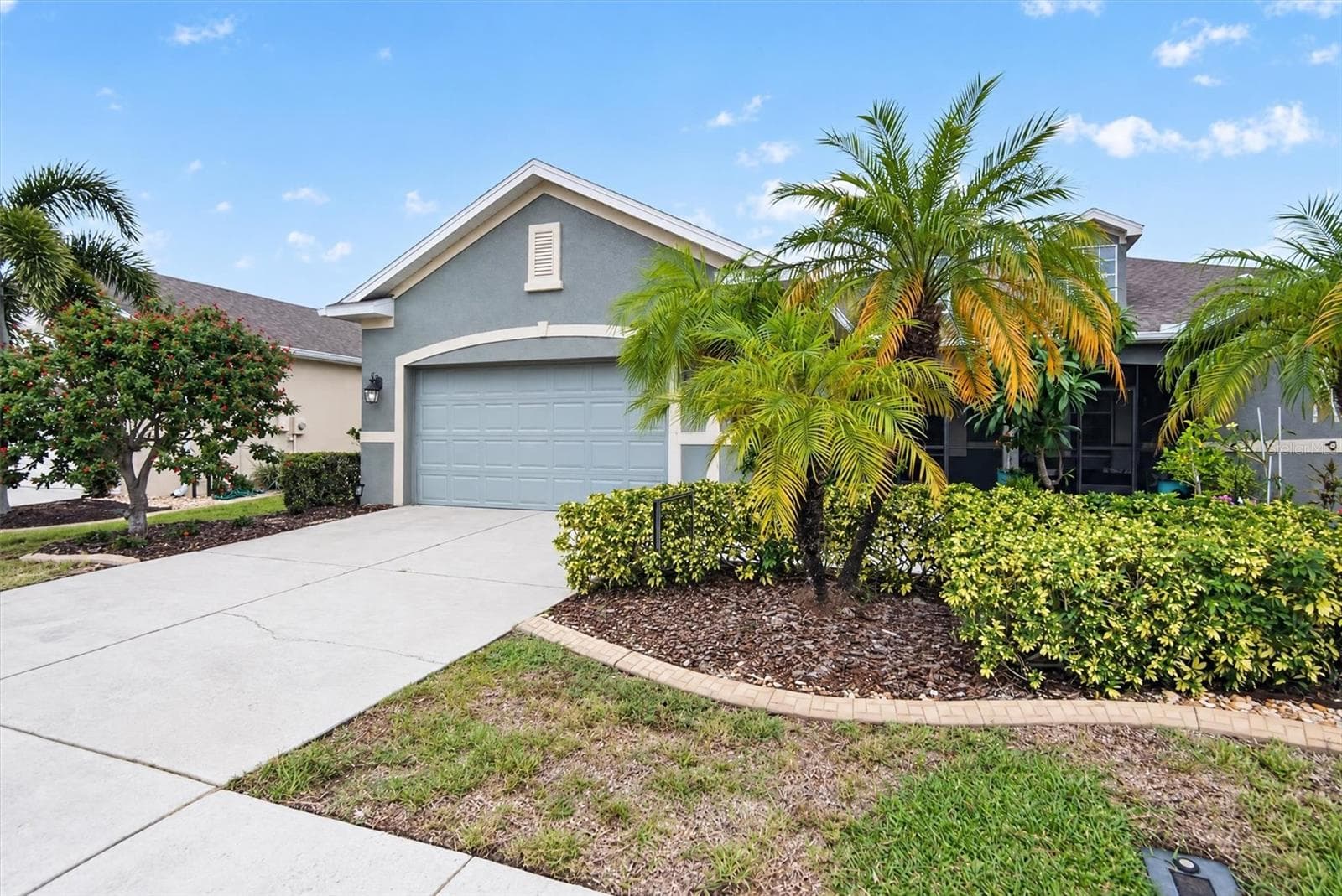 Additional view of the home's front exterior and landscaped driveway. - 2153 BARRACUDA CT, HOLIDAY