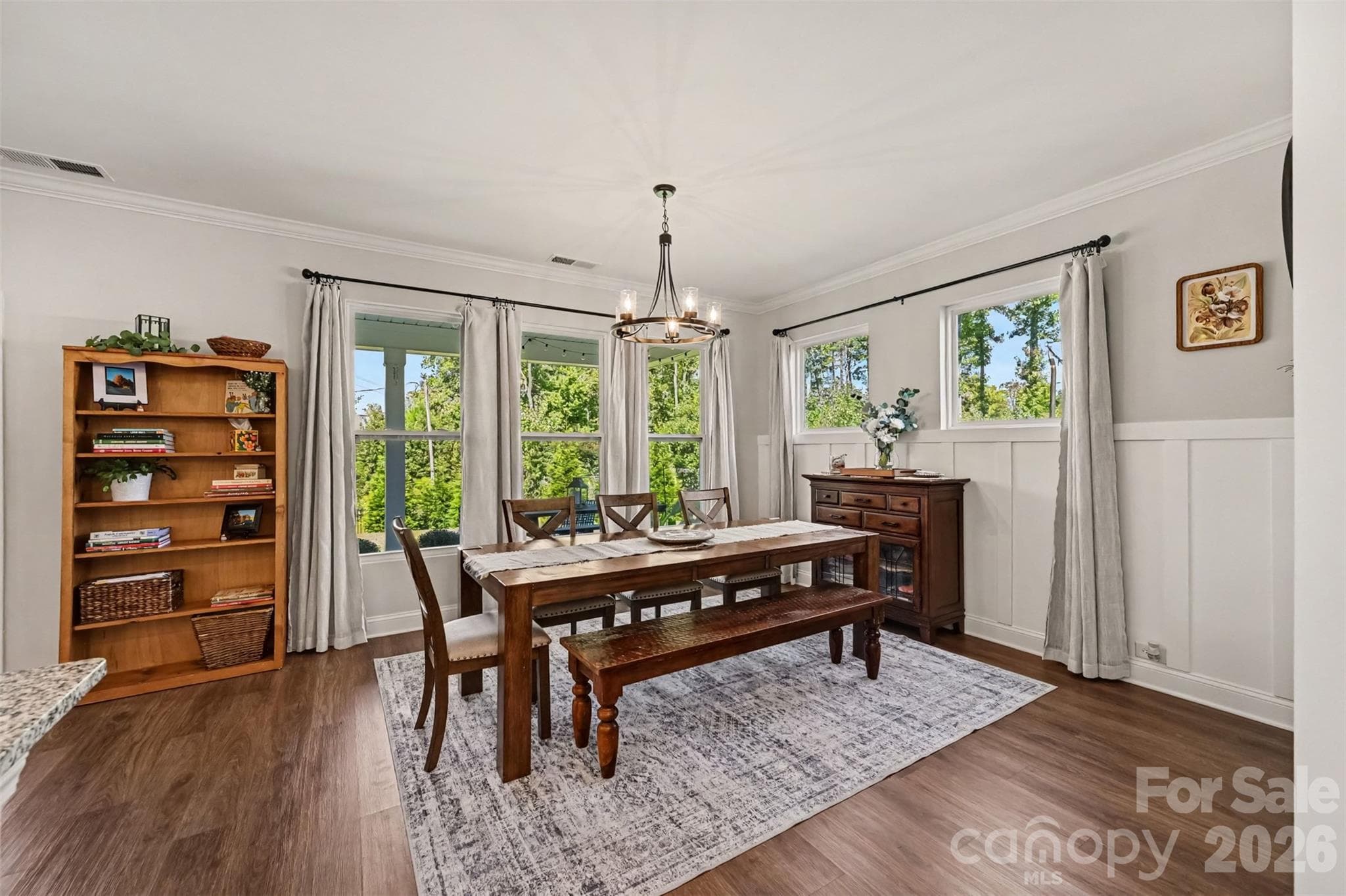 A dining area with room for a full-size table, wainscoting accents, and backyard views. - 2703 Wedgewood Court, Denver