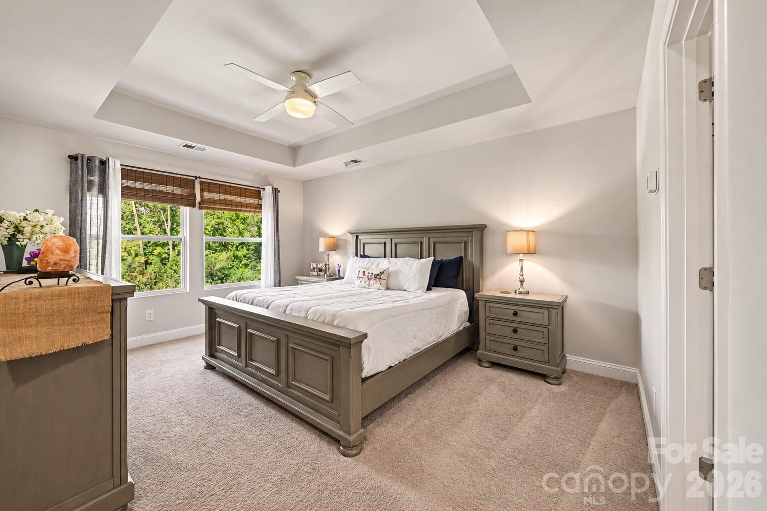 The primary suite is a true retreat with a tray ceiling and a wall of windows. - 2703 Wedgewood Court, Denver