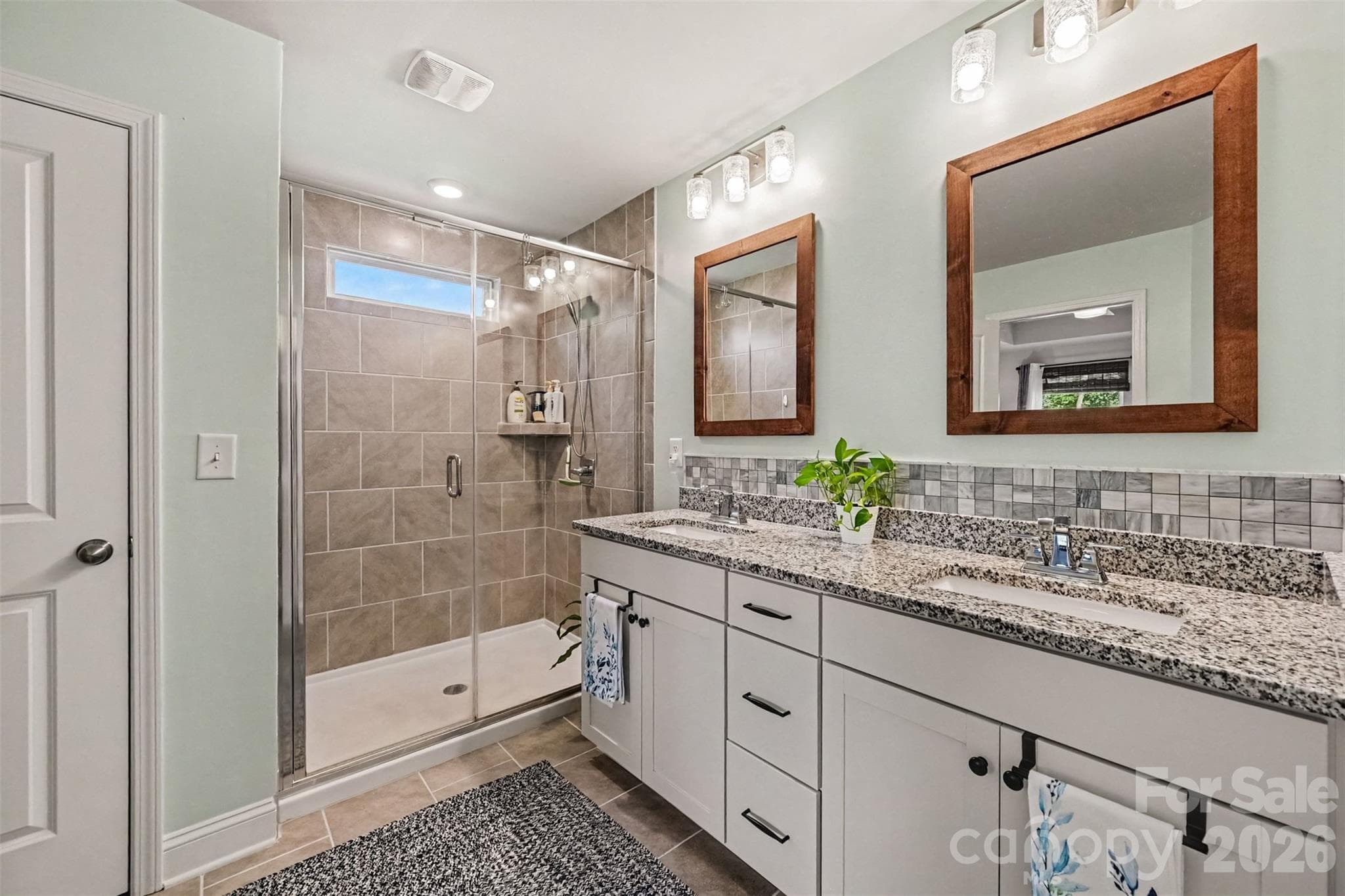 Tile accents, framed mirrors, and space to get ready side by side. - 2703 Wedgewood Court, Denver