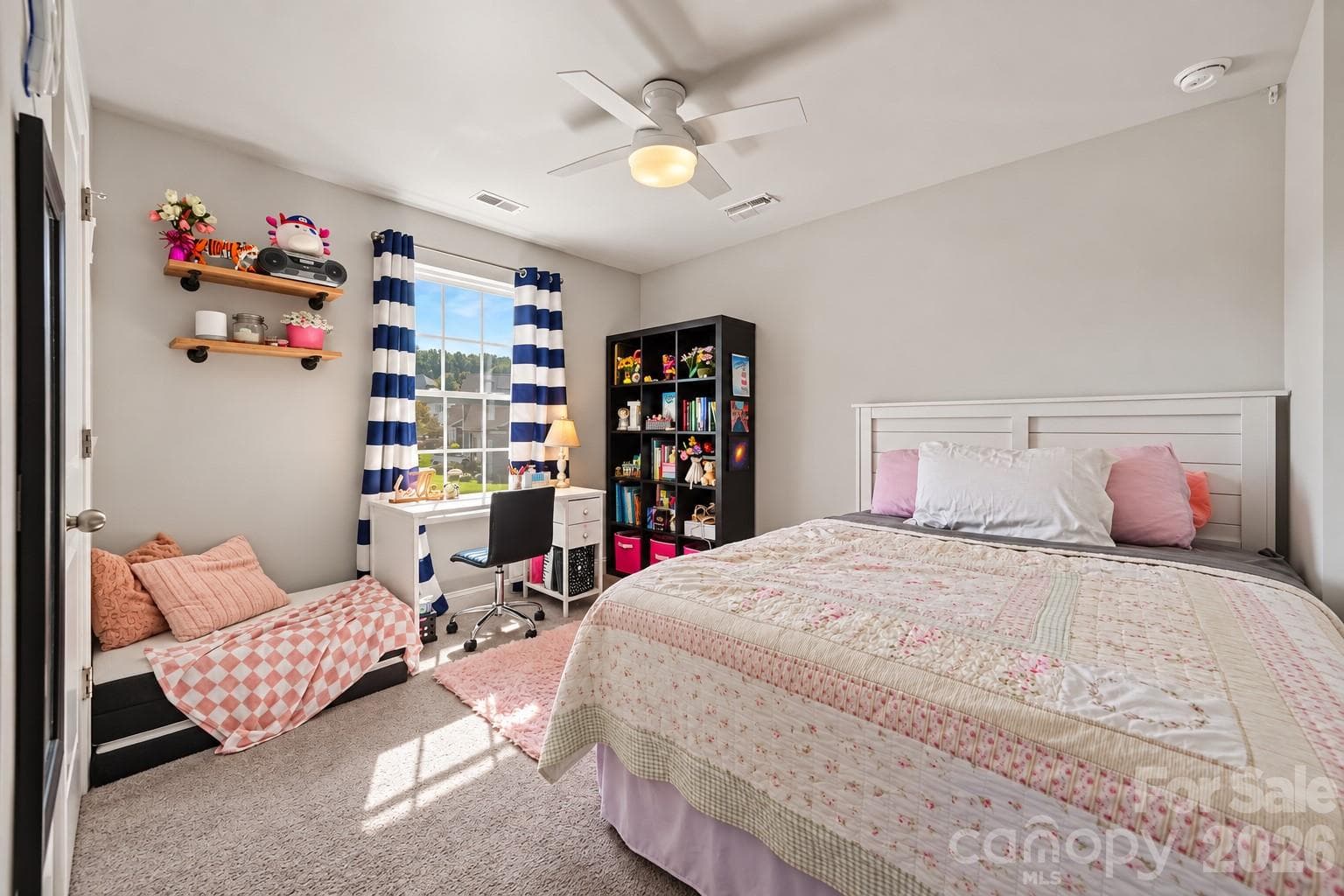 A bright secondary bedroom filled with natural light. - 2703 Wedgewood Court, Denver