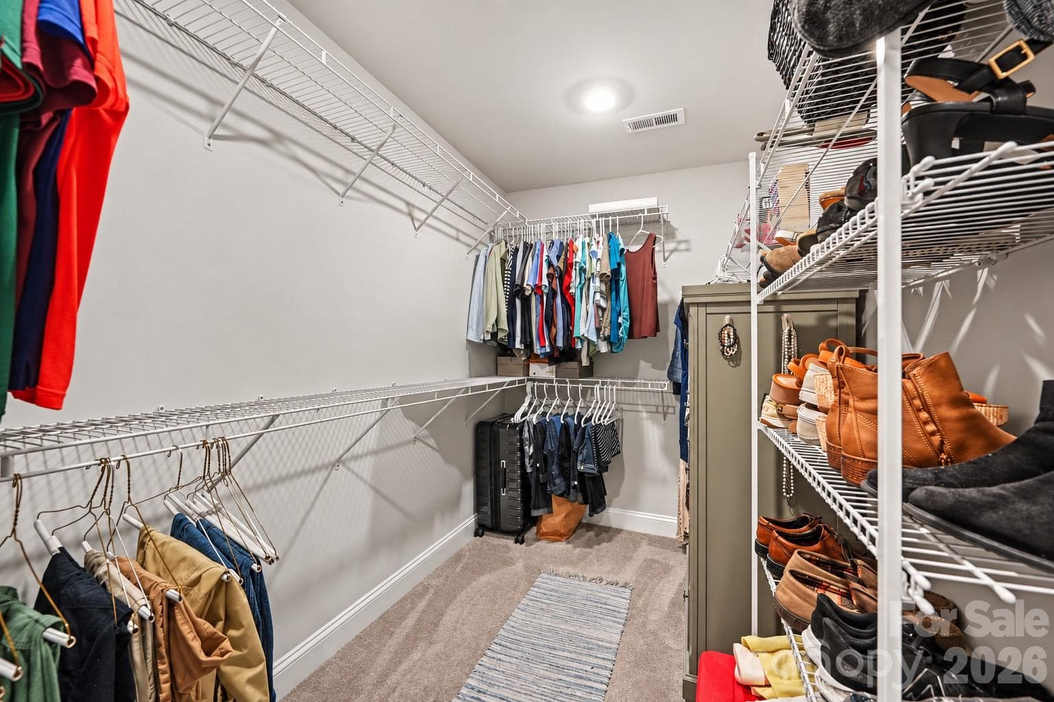 A walk-in closet with built-in shelving and room for the whole wardrobe. - 2703 Wedgewood Court, Denver