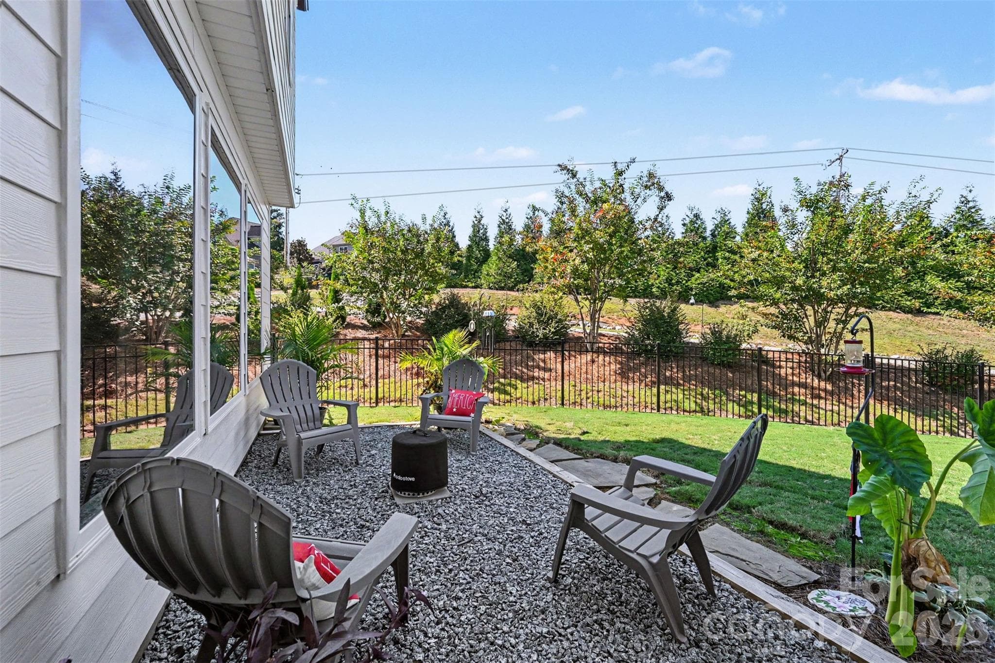 A gravel patio sitting area just off the back porch. - 2703 Wedgewood Court, Denver