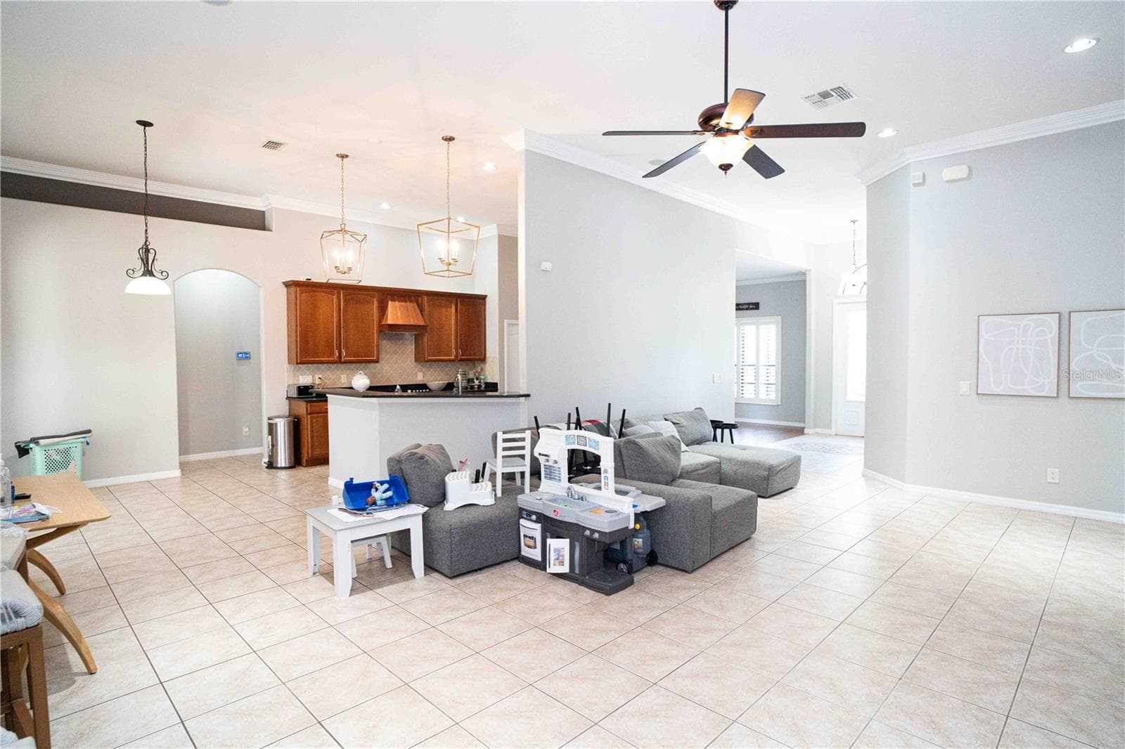 view of living room and kitchen toward the front door - 15418 PRINCEWOOD LN, LAND O LAKES