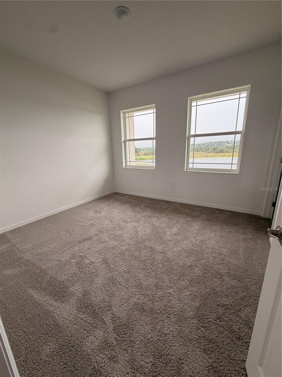 Master Bedroom with lake view - 915 LAKEFRONT VILLAGE DR, CLERMONT