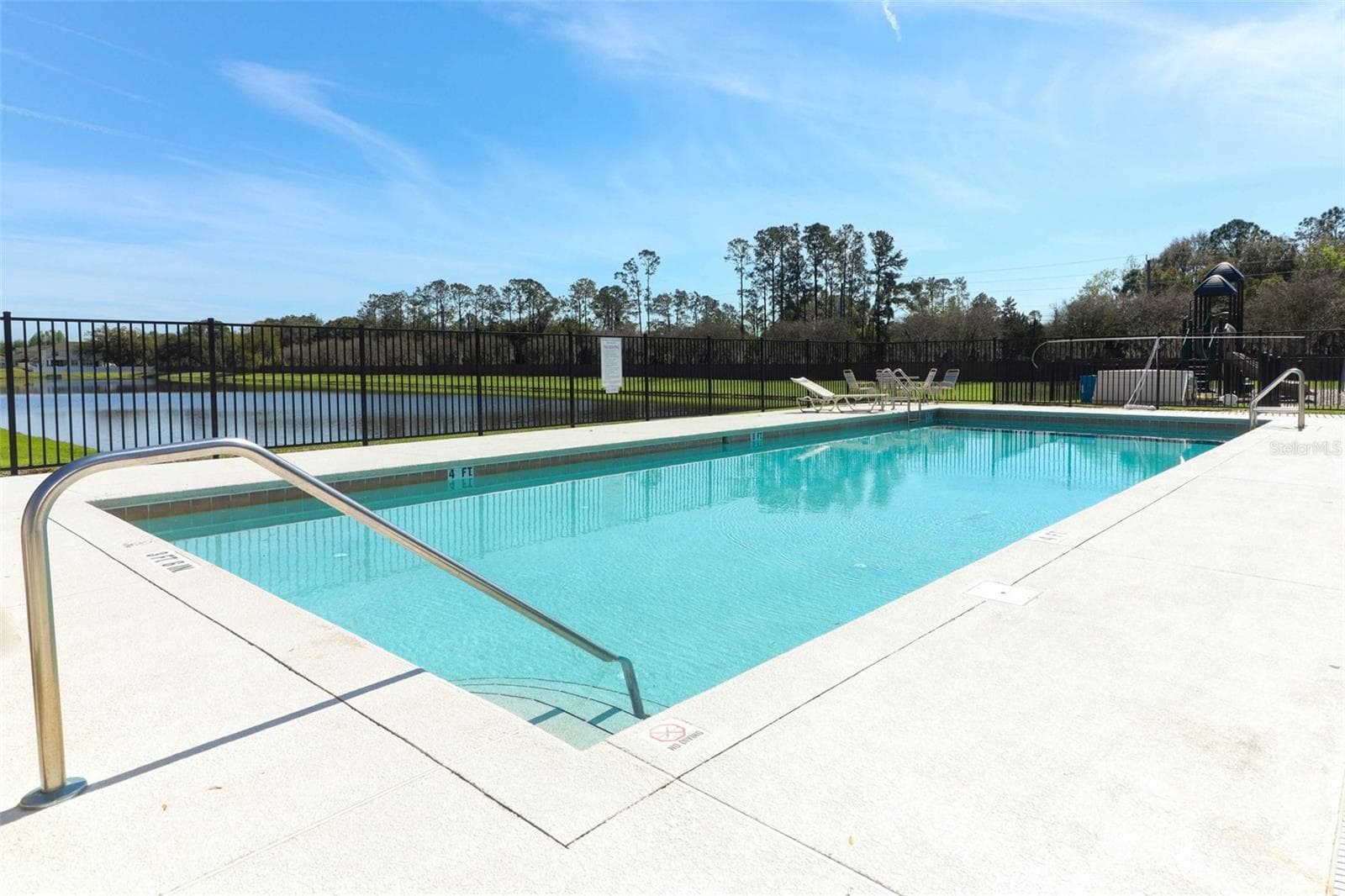 Community pool overlooking a beautiful lake view - 284 CLYDESDALE CIR, SANFORD