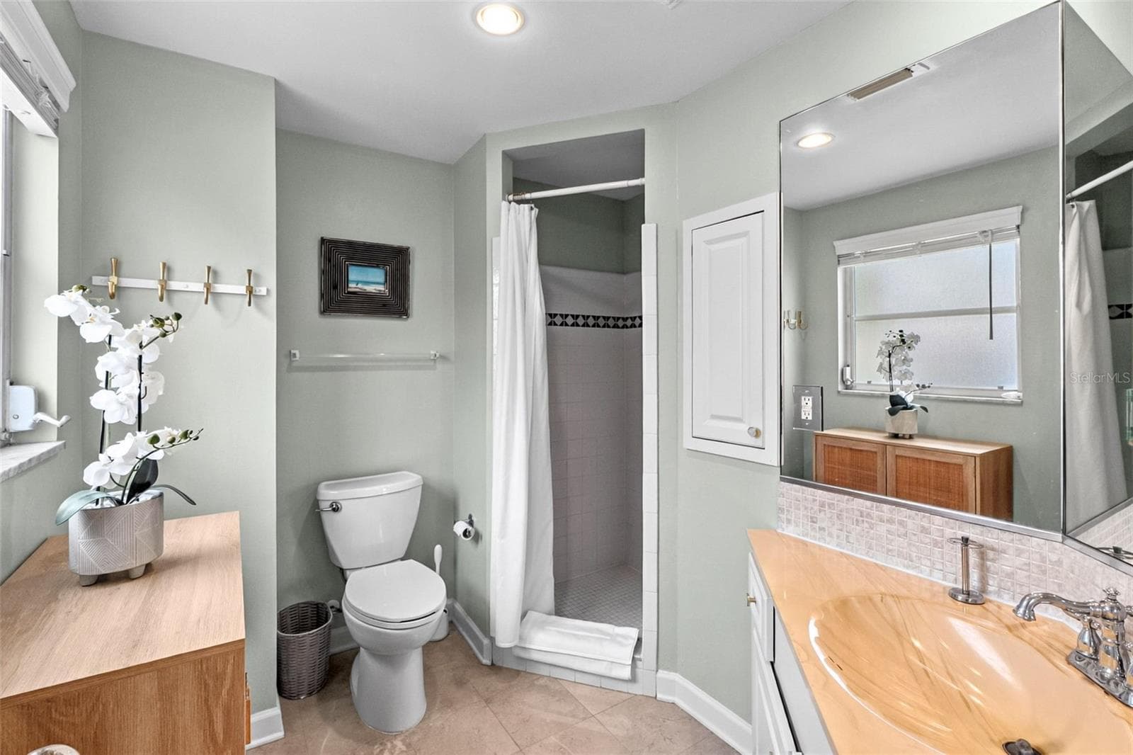 Primary bathroom with vintage clamshell-style sink and shower. - 912 CHURCH ST, VENICE