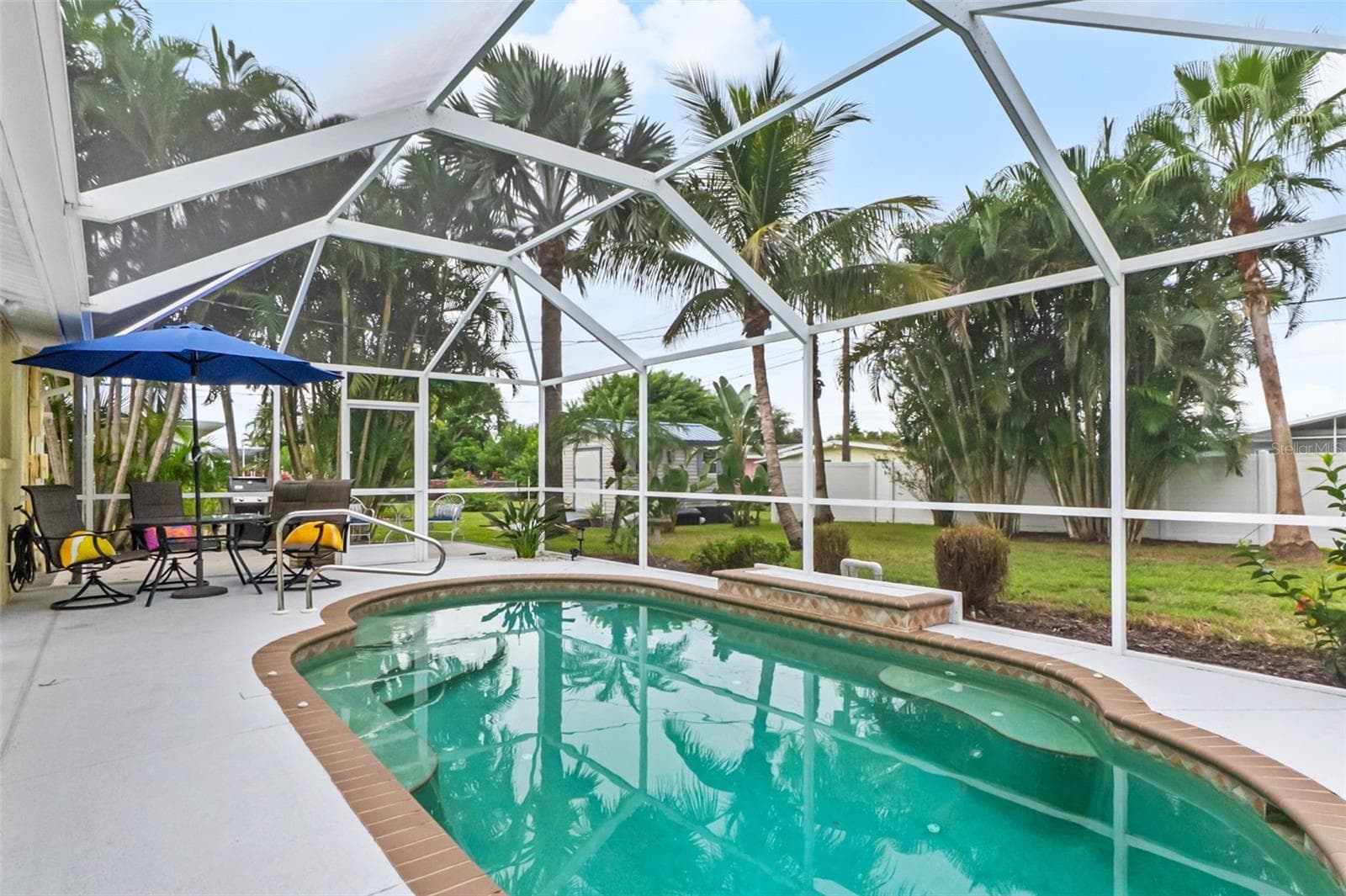 Alternate view of the pool with poolside seating and outdoor dining area. - 912 CHURCH ST, VENICE