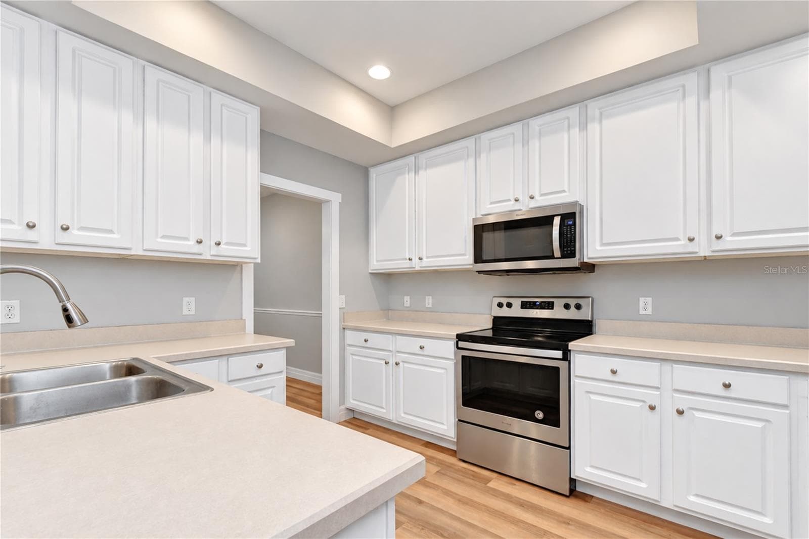 Functional kitchen features 42-inch cabinetry, ample counter space, and stainless steel appliances. - 828 LUMSDEN RESERVE DR, BRANDON