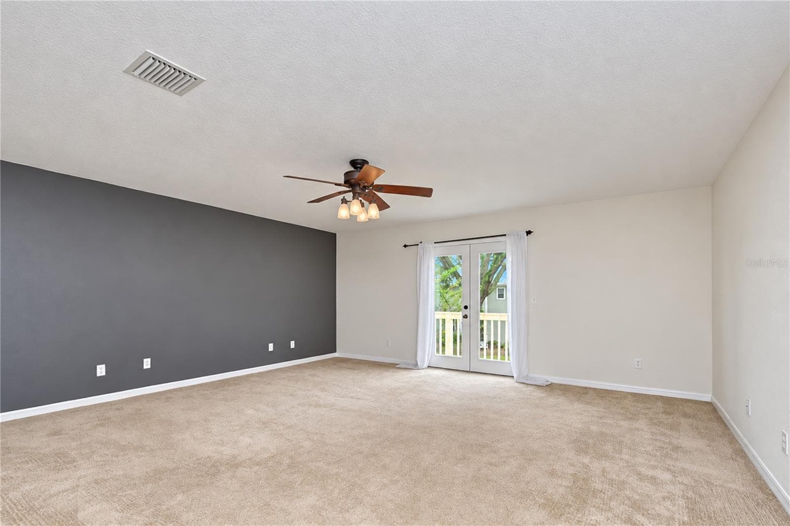 French doors open from the primary suite to a private balcony. - 828 LUMSDEN RESERVE DR, BRANDON