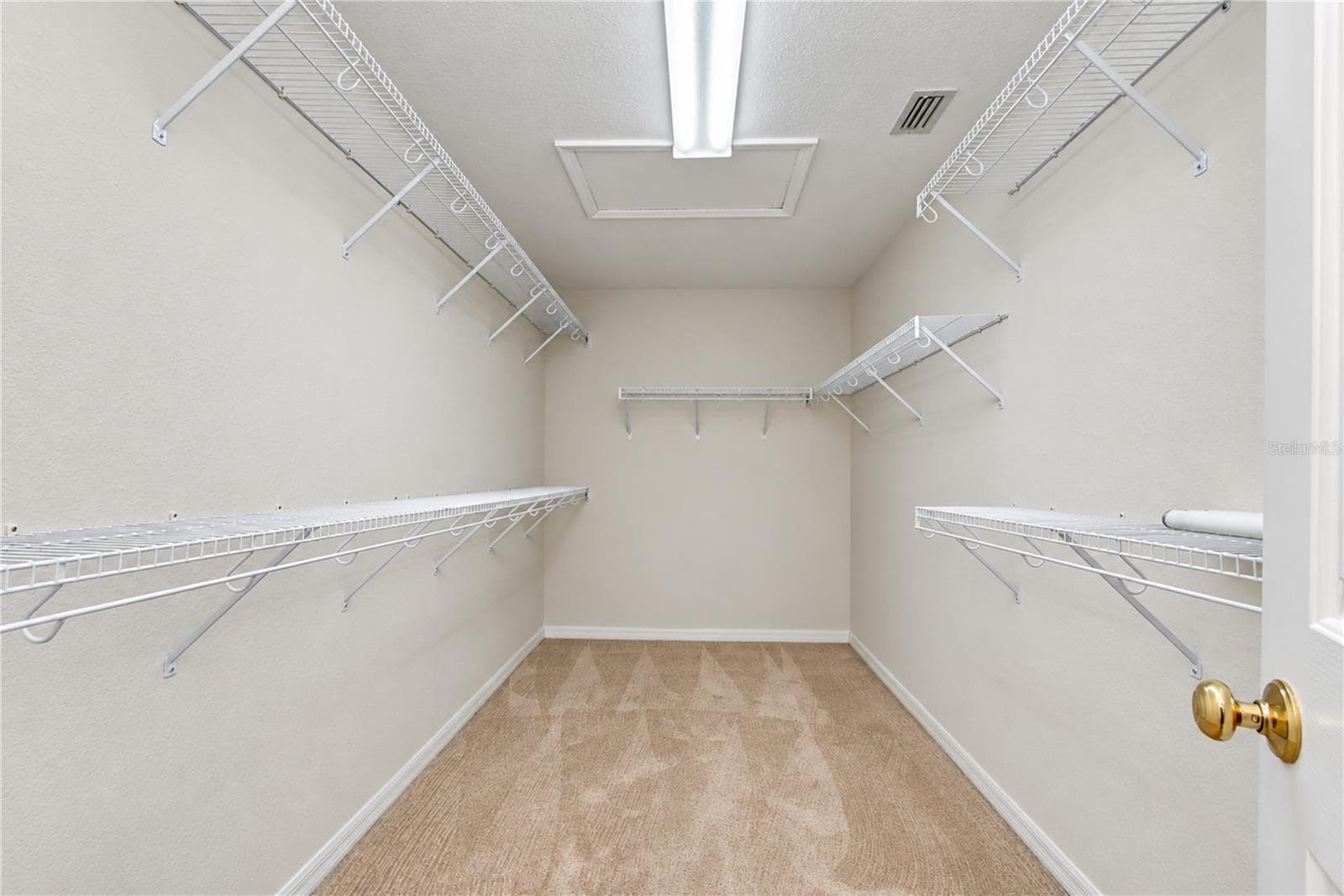 Oversized walk-in closet offers abundant storage and organization. - 828 LUMSDEN RESERVE DR, BRANDON