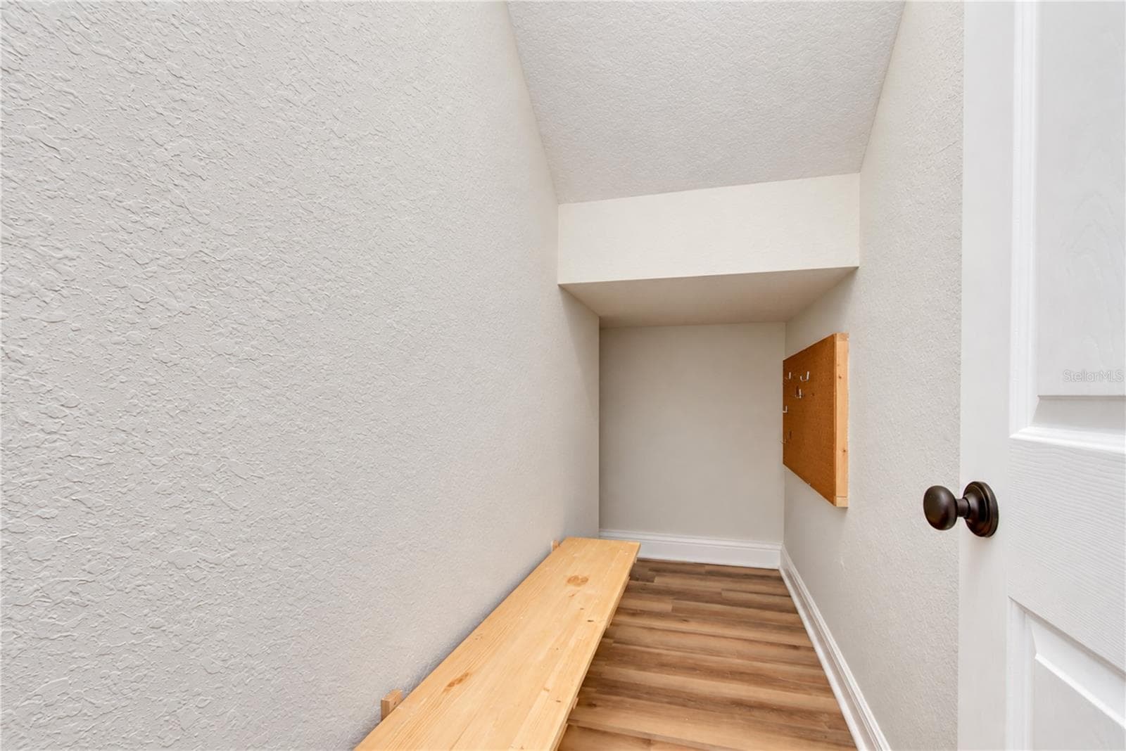 Convenient storage beneath the staircase provides additional space for household essentials. - 828 LUMSDEN RESERVE DR, BRANDON