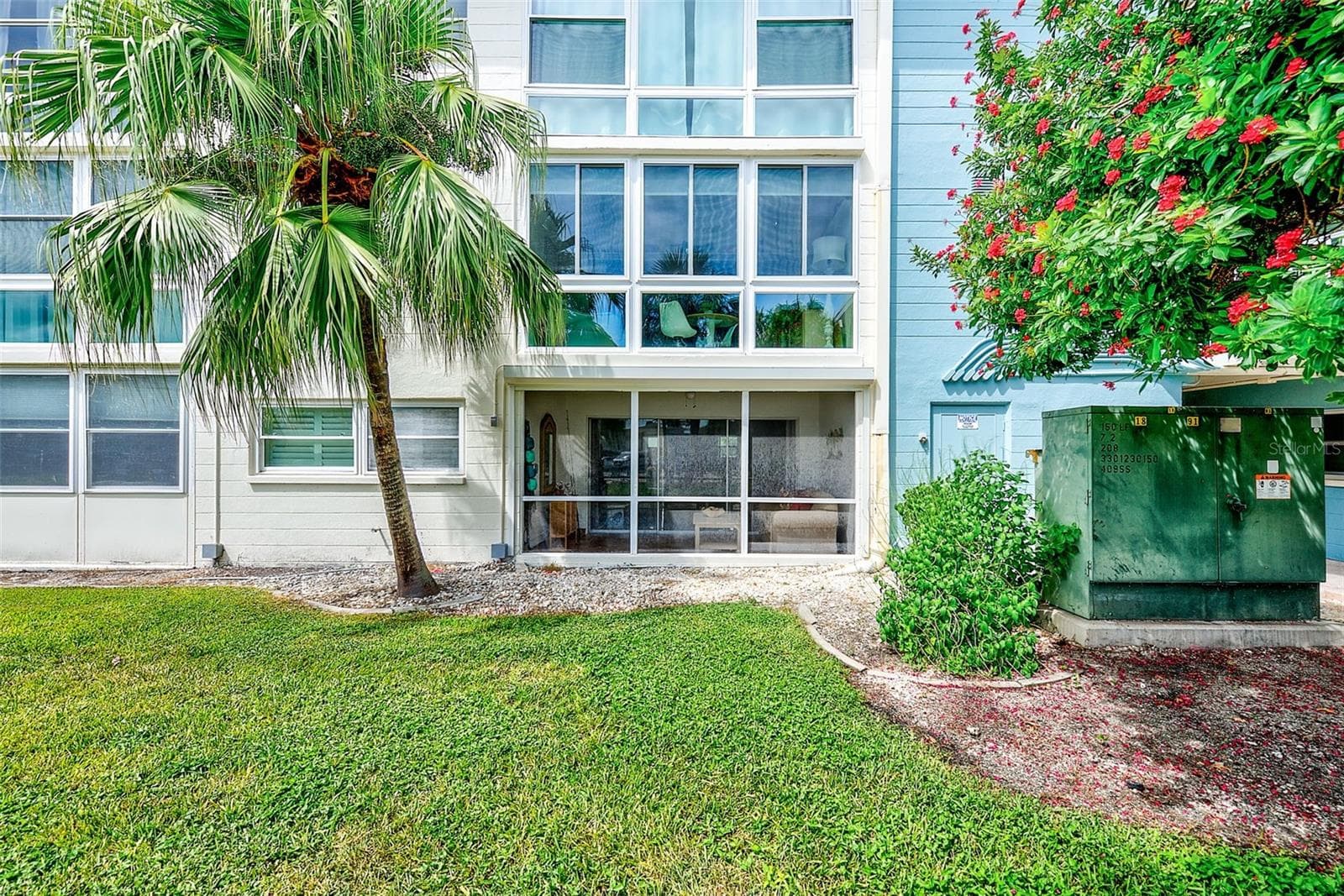 Rear of Condo and view of the storm shutters - 6201 2ND ST E #74, ST PETE BEACH