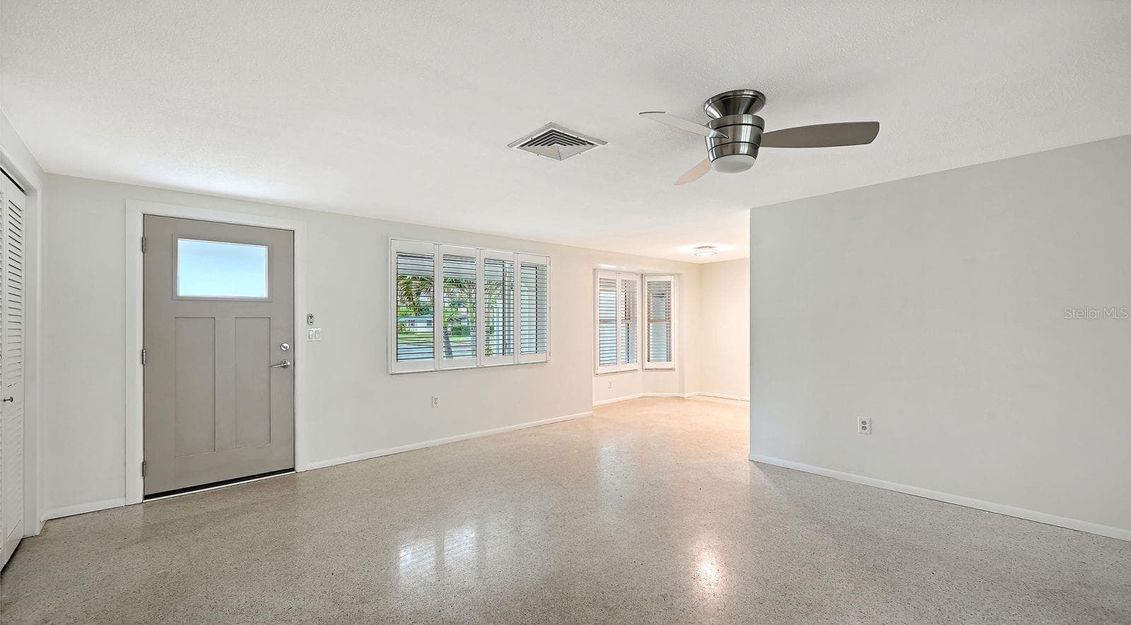 Living and Dining Rooms with Attractive Plantation Shutters - 2610 REGATTA DR, SARASOTA
