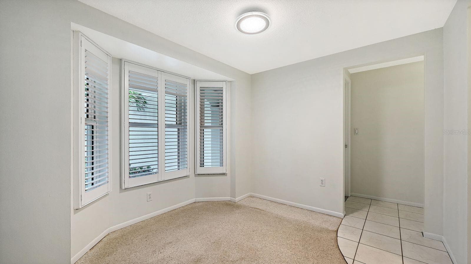 Dining Room with a Bay Window with Plantation Shutters - 2610 REGATTA DR, SARASOTA
