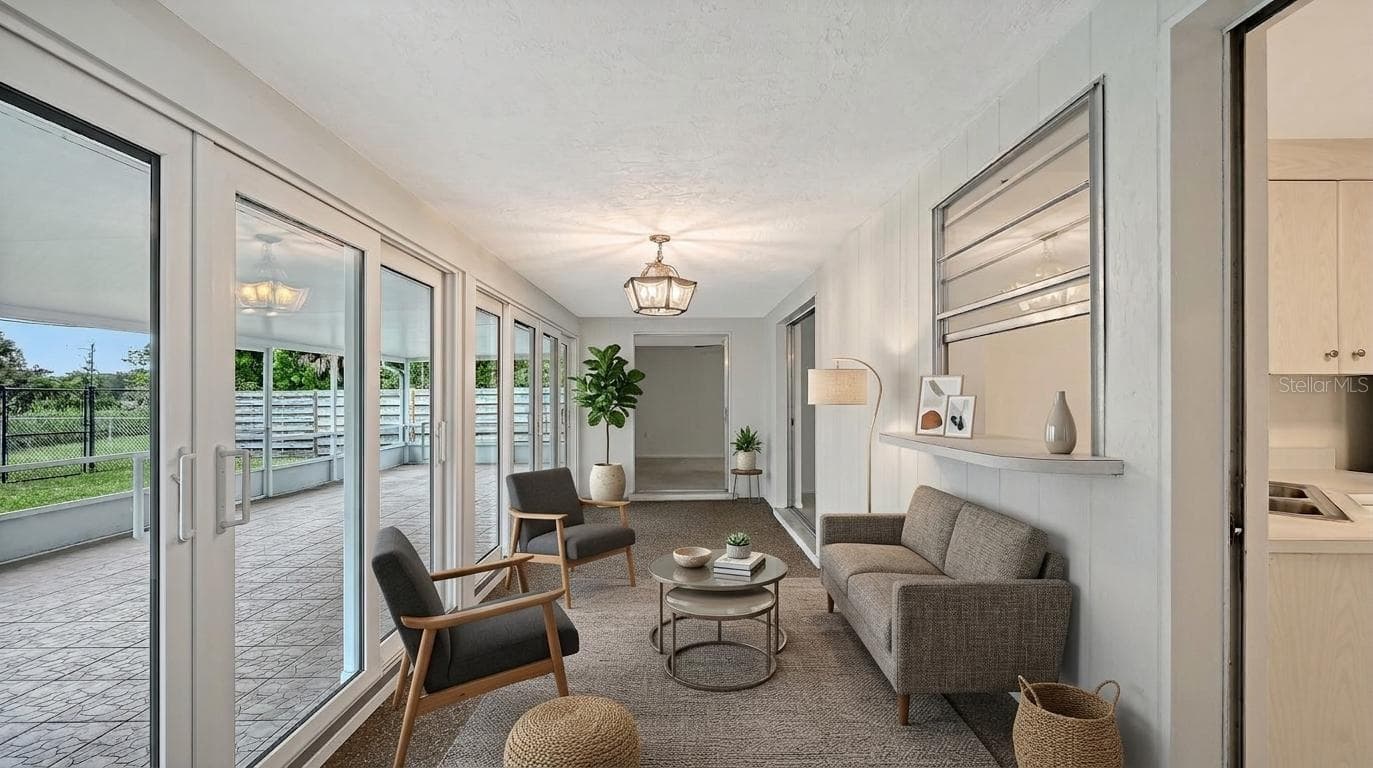 Staged Florida Room with Newer Impact Resistant Sliding Glass Doors all the way across! - 2610 REGATTA DR, SARASOTA