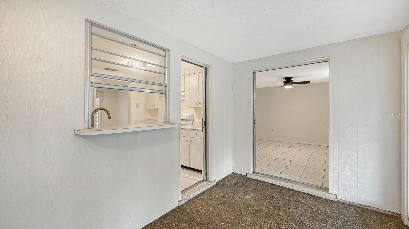Pass thru window and door from the Kitchen to the Florida Room - 2610 REGATTA DR, SARASOTA