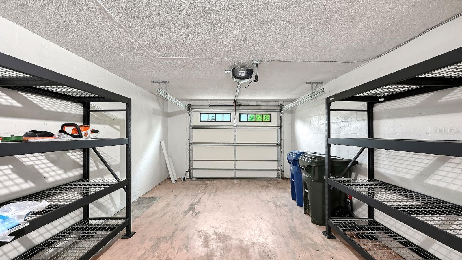 Spacious, One Car Garage with a Hurricane Garage Door & Storage Racks - 2610 REGATTA DR, SARASOTA