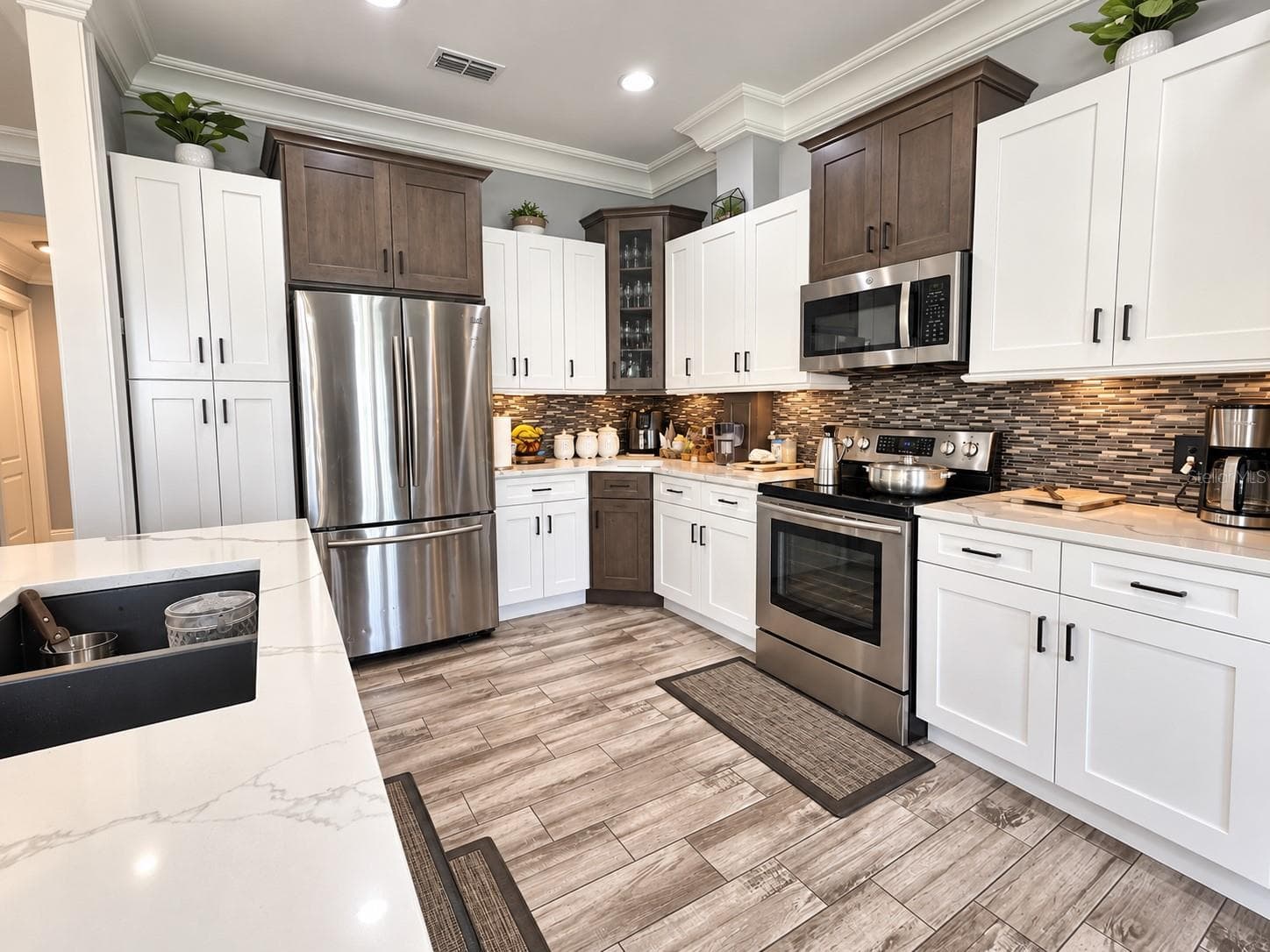 Beautiful kitchen featuring two-tone cabinetry - 3998 PEMBERLY PINES CIR, ST CLOUD