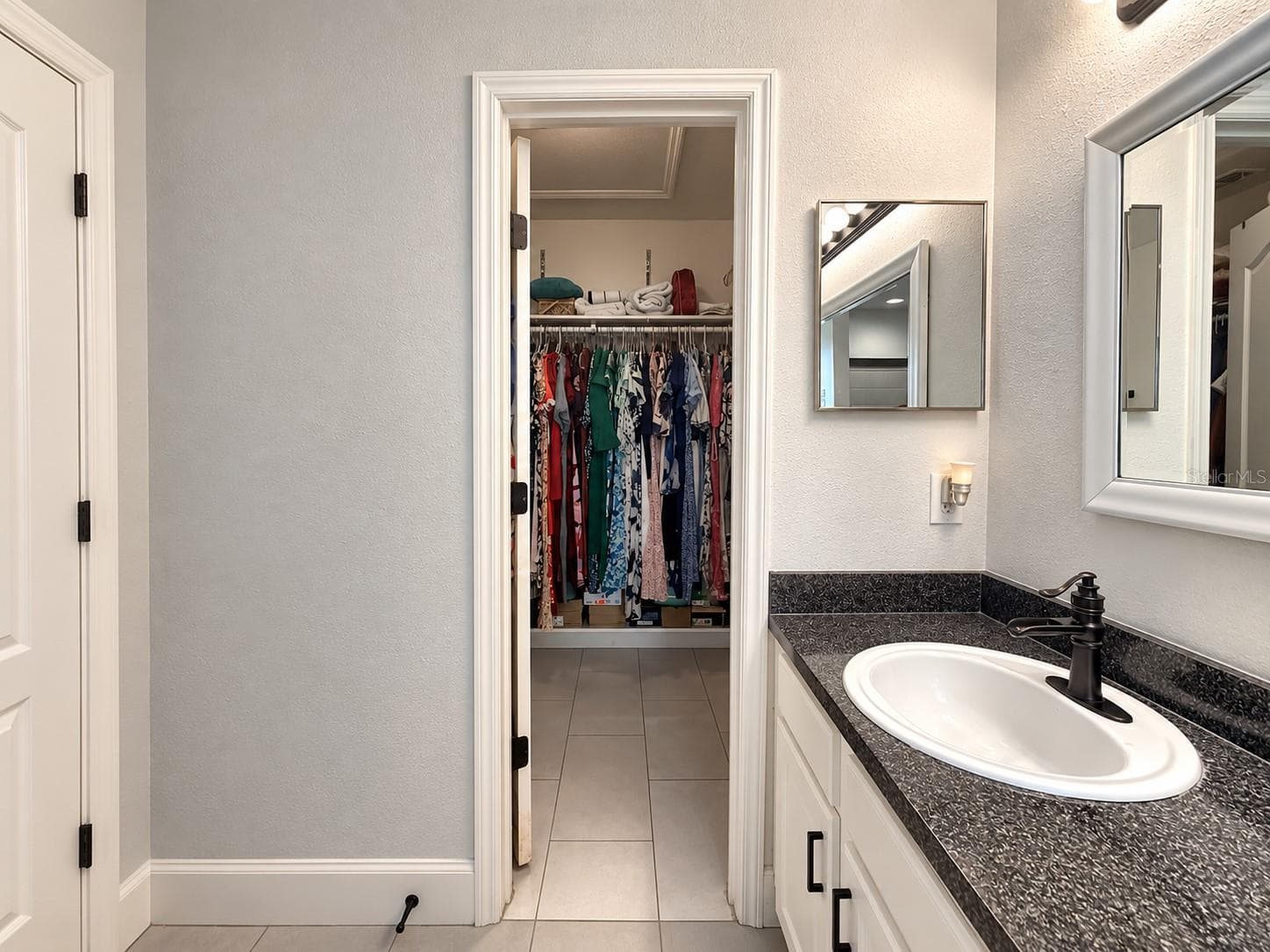 Primary bathroom with access to a spacious walk-in closet. - 3998 PEMBERLY PINES CIR, ST CLOUD